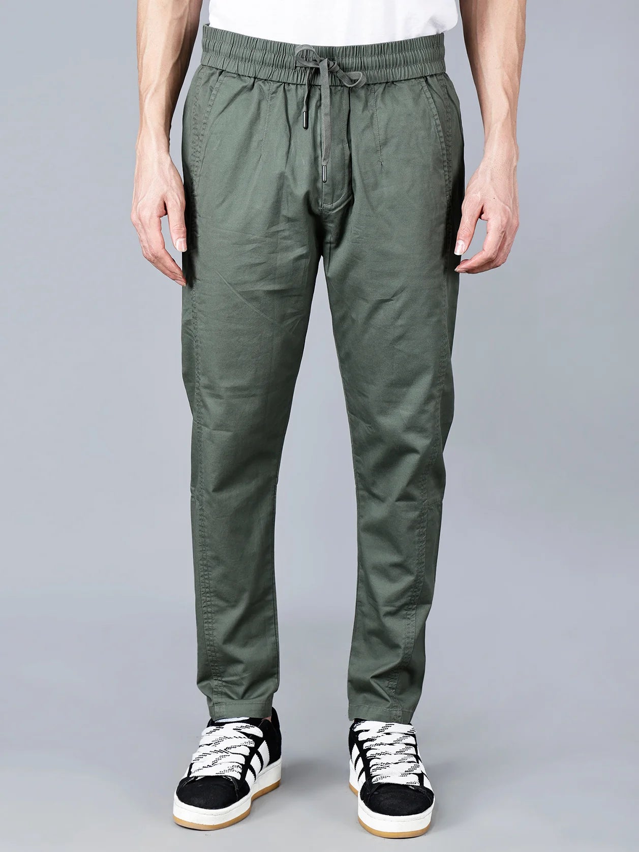 Green cotton track pants for men by Fort Collins featuring a smart taper fit, elastic waistband with drawstring, and multi-pocket design for casual everyday wear. Show now online for trendy track pant in India.