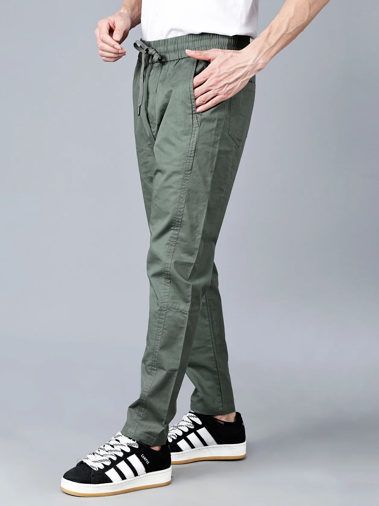 Discover the ultimate comfort and style with Fort Collins' Green Cotton Track Pants for Men. With a sleek taper fit, elastic waistband and drawstring closure, and multi-pocket design, these track pants are perfect for casual everyday wear. Shop now for a trendy, top-quality track pant made with green cotton in India.
