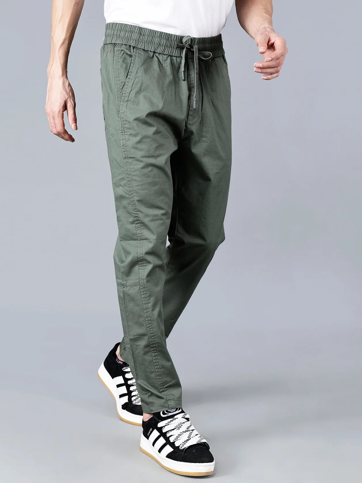Discover the perfect balance of comfort and style in Fort Collins' Green Cotton Track Pants for Men. With its tapered fit, elastic waistband, and multi-pocket design, these track pants are perfect for everyday casual wear. Shop now for a trendy addition to your wardrobe, available online in India.