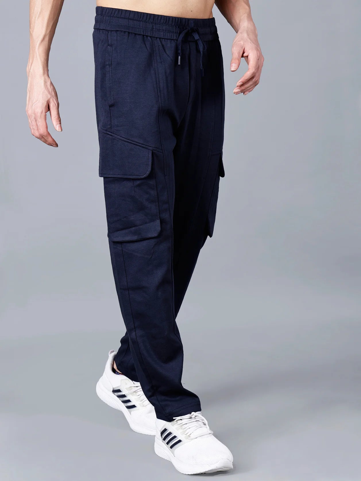 Expertly crafted for ultimate comfort and versatile style, these Men's Navy Blue Cargo Track Pant for Men feature durable cotton-polyester fabric, an elastic waistband, and cargo flap pockets. Perfect for any occasion, shop now online from anywhere in India.