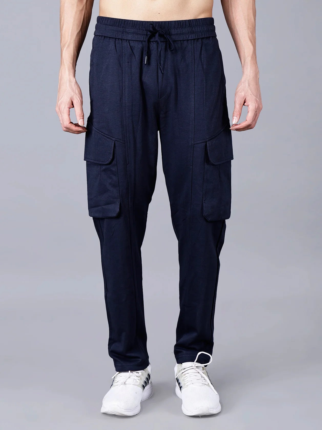 Introducing Fort Collins Men's Navy Blue Cargo Track Pant, designed with functional cargo flap pockets, an elastic waistband, and a sturdy cotton-polyester fabric for ultimate comfort and stylish streetwear. Now available to buy online from anywhere in India.