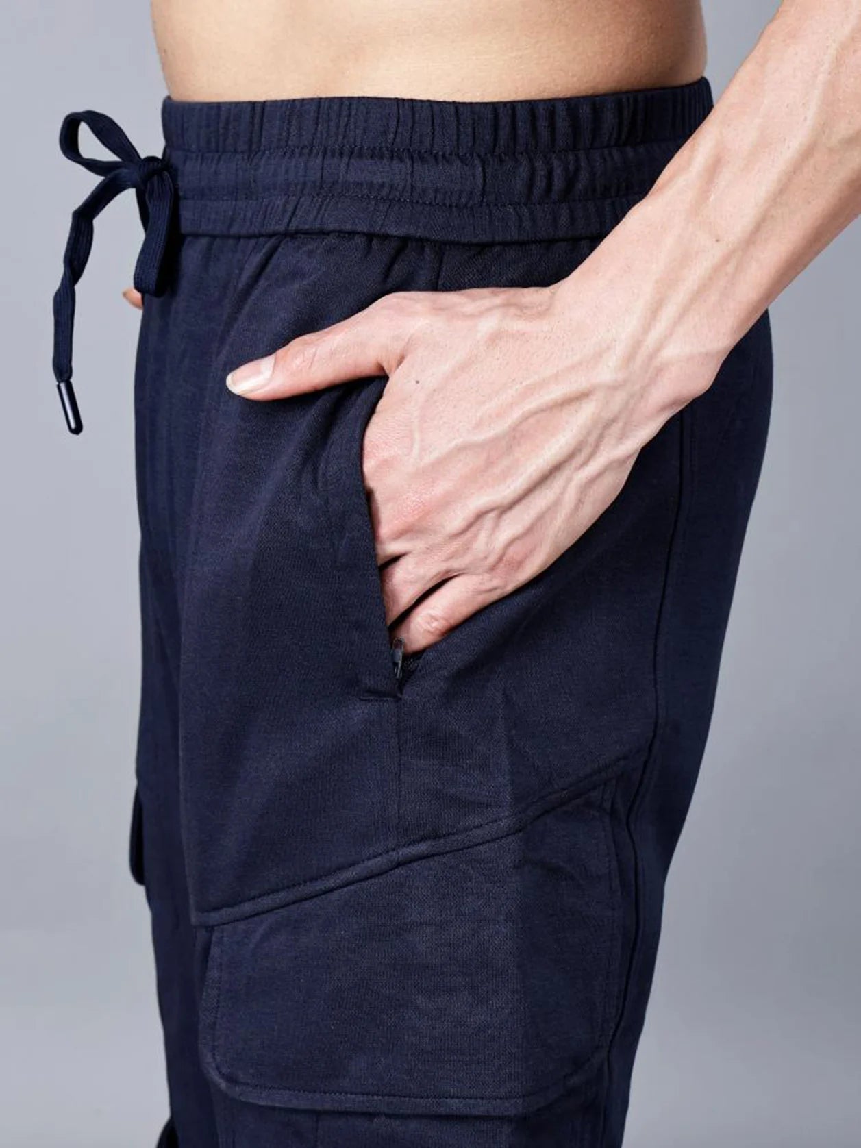 Get the perfect balance of everyday comfort and streetwear-ready style with Fort Collins' Navy Blue cargo track pant for men. Featuring cargo flap pockets, an elastic waistband, and structured cotton-polyester fabric, these pants are a must-have for any wardrobe. Shop now online from anywhere in India.