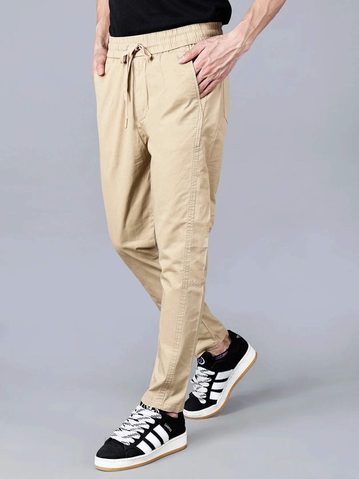 Buy the Men's Beige Cotton Track Pant with Elastic Waistband and Drawstring Closure from Fort Collins - an ideal combination of style and comfort. With its multiple pockets and modern tapered fit, this track pant is perfect for casual wear. Shop now from anywhere in India.