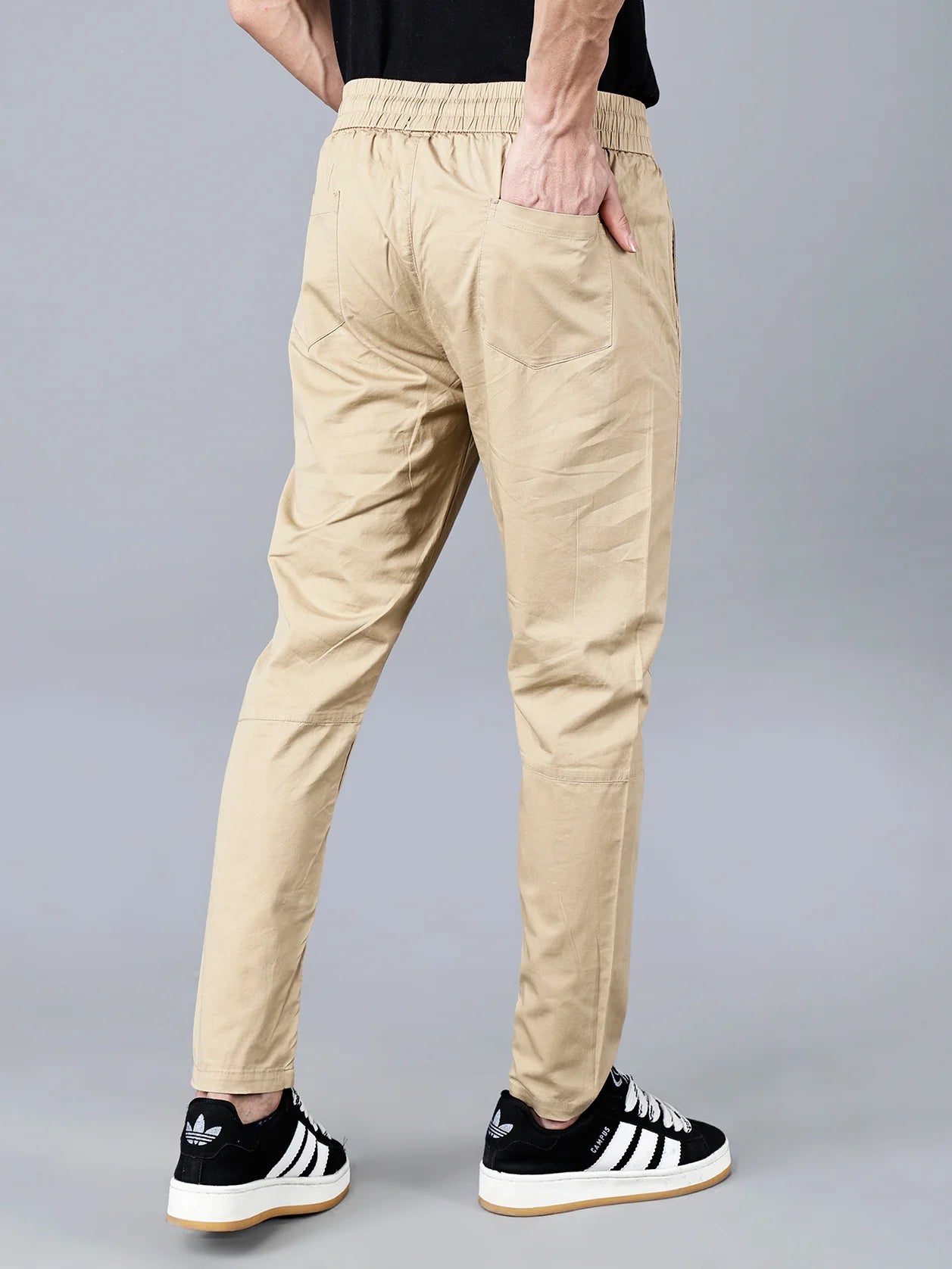 Experience the high-quality Men's Beige Cotton Track Pant with Comfortable Elastic Waistband and Adjustable Drawstring Closure. Featuring a sleek multi-pocket design and modern tapered fit, these pants provide both style and breathability. Available to buy online from anywhere in India.