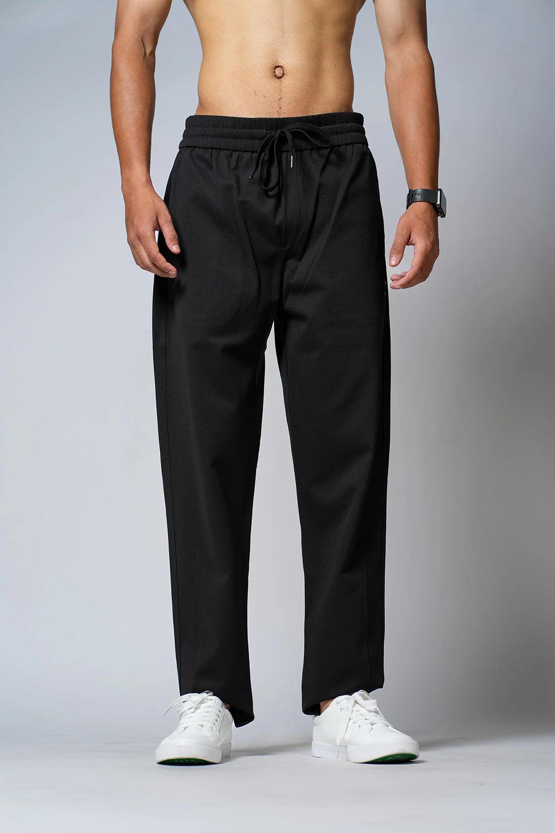 Discover the versatility and functionality of Men's Black Regular Fit Polyester Track Pant with Zipper Pockets, available now in India from Fort Collins.