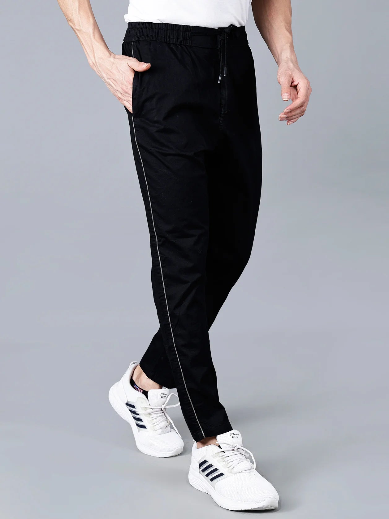 Experience ultimate comfort and style with the Fort Collins Black Slim Fit Men's Track Pants. These joggers feature a sleek side stripe design and a stretchable fabric, making them perfect for casual and active wear. Buy now online from anywhere in India.