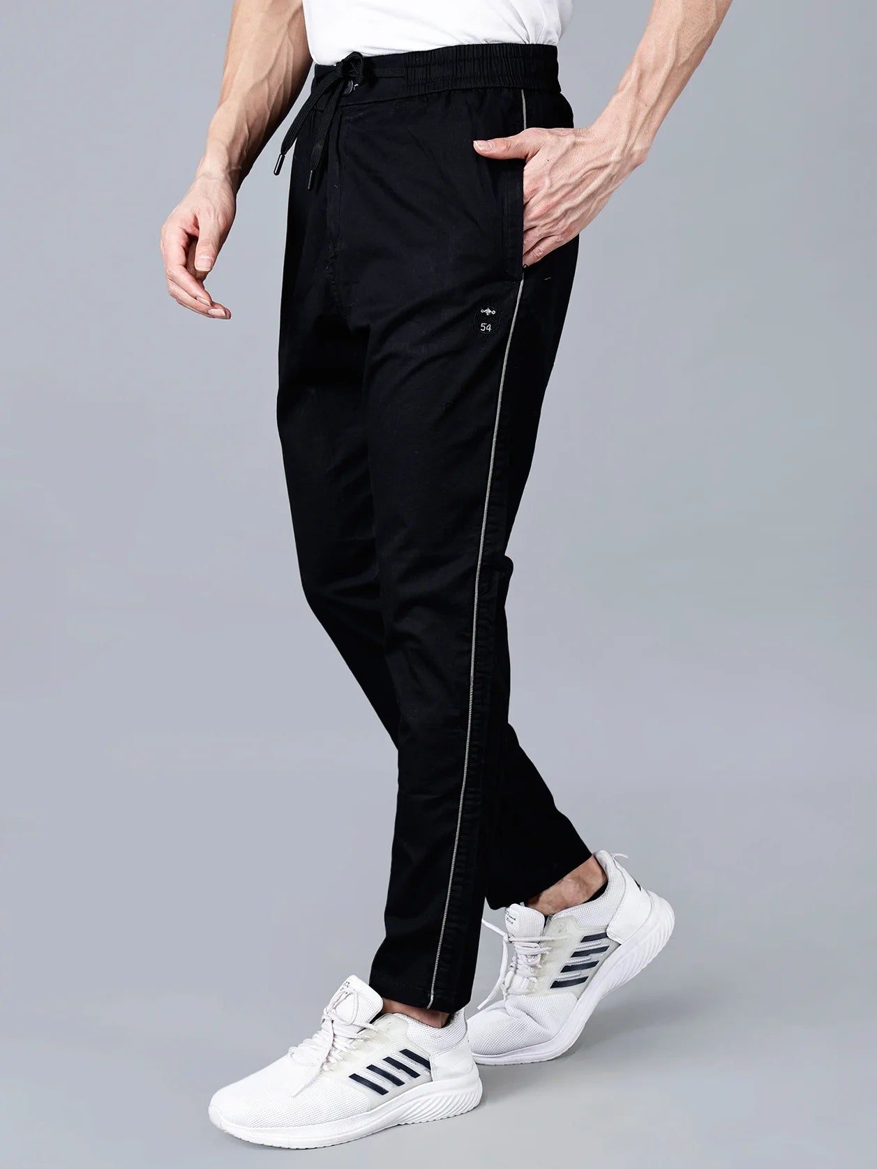 Explore the stylish and versatile Men's Black Slim Fit Track Pant with Side Stripe from Fort Collins - perfect for both casual and active occasions. Available for purchase online in India.