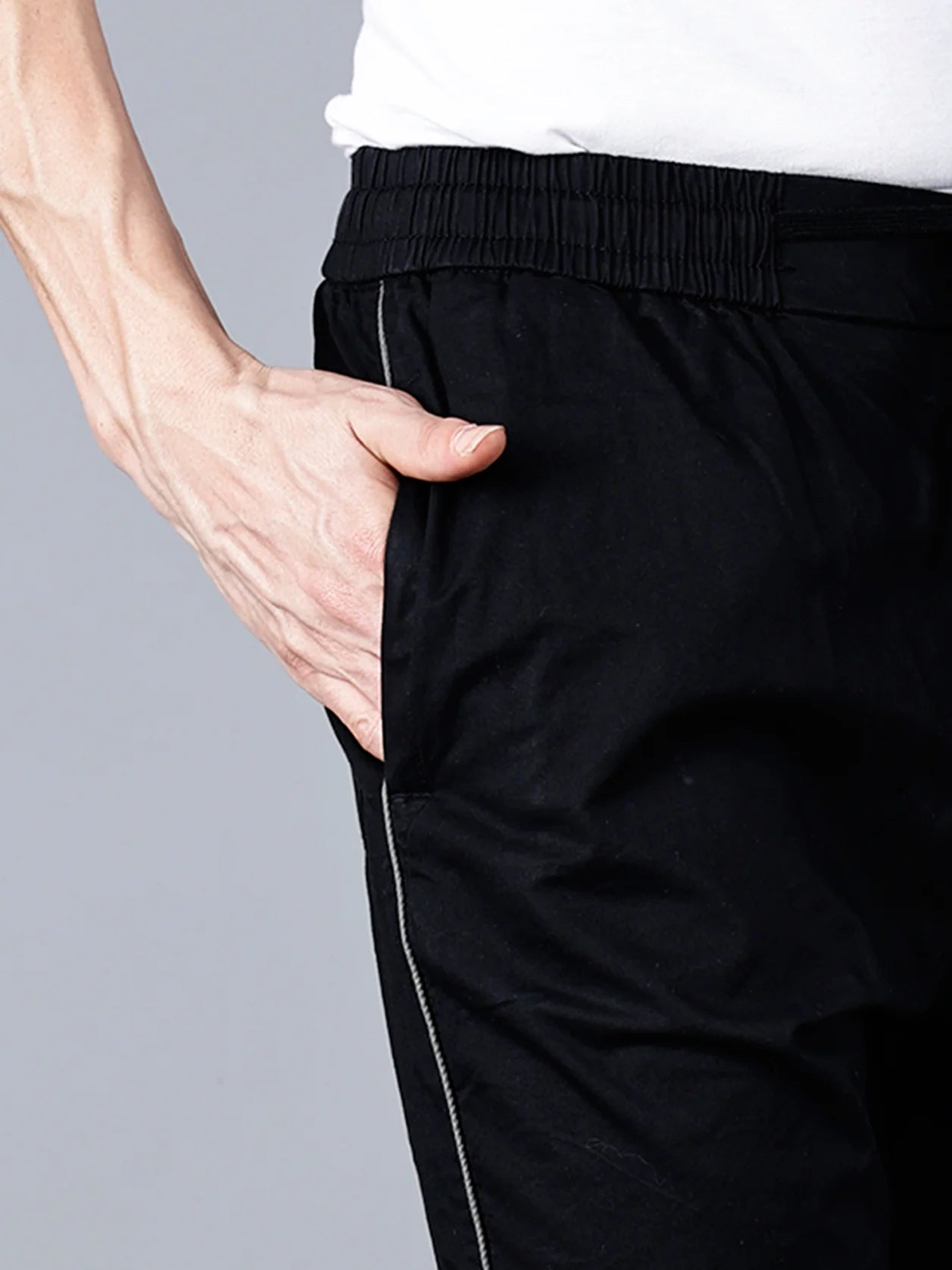 Shop now for the Men's Black Slim Fit Track Pant with Side Stripe from Fort Collins. These stylish and stretchable joggers are perfect for both casual and active wear, and can be purchased online from anywhere in India.