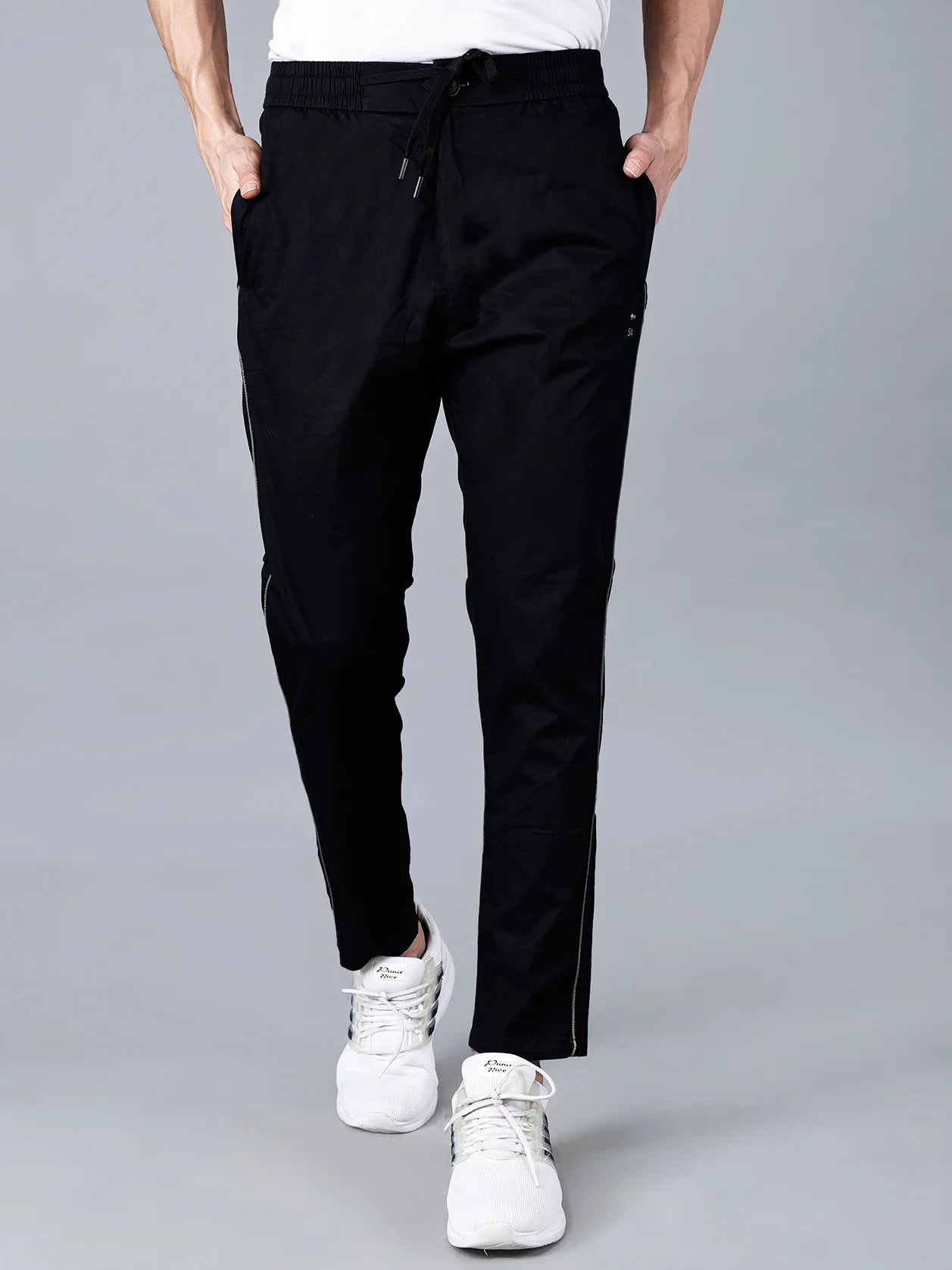 Fort Collins black slim fit men's track pants with side stripe – stylish and stretchable joggers for casual and active wear. Shop now online from anywhere in India.