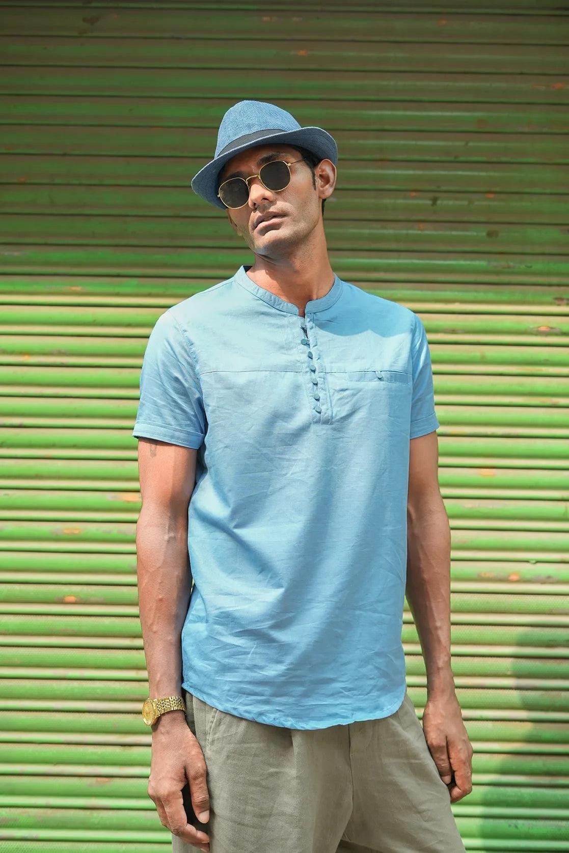 Refresh your wardrobe with the Men's Blue Relaxed Fit Mandarin Collar T-Shirt Kurta from Fort Collins. This timeless piece offers a comfortable and stylish fit, perfect for any occasion.