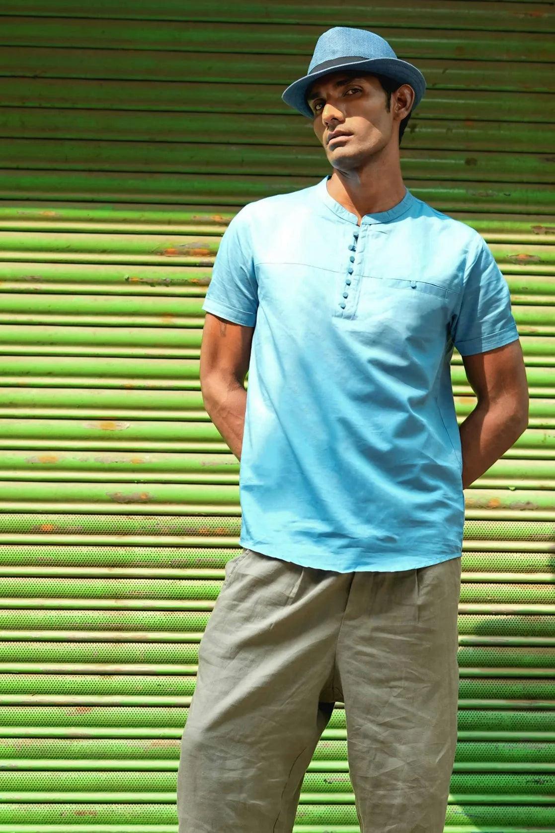 This Men's Blue Relaxed Fit Mandarin Collar T-Shirt Kurta features a chest pocket and is designed by Fort Collins.