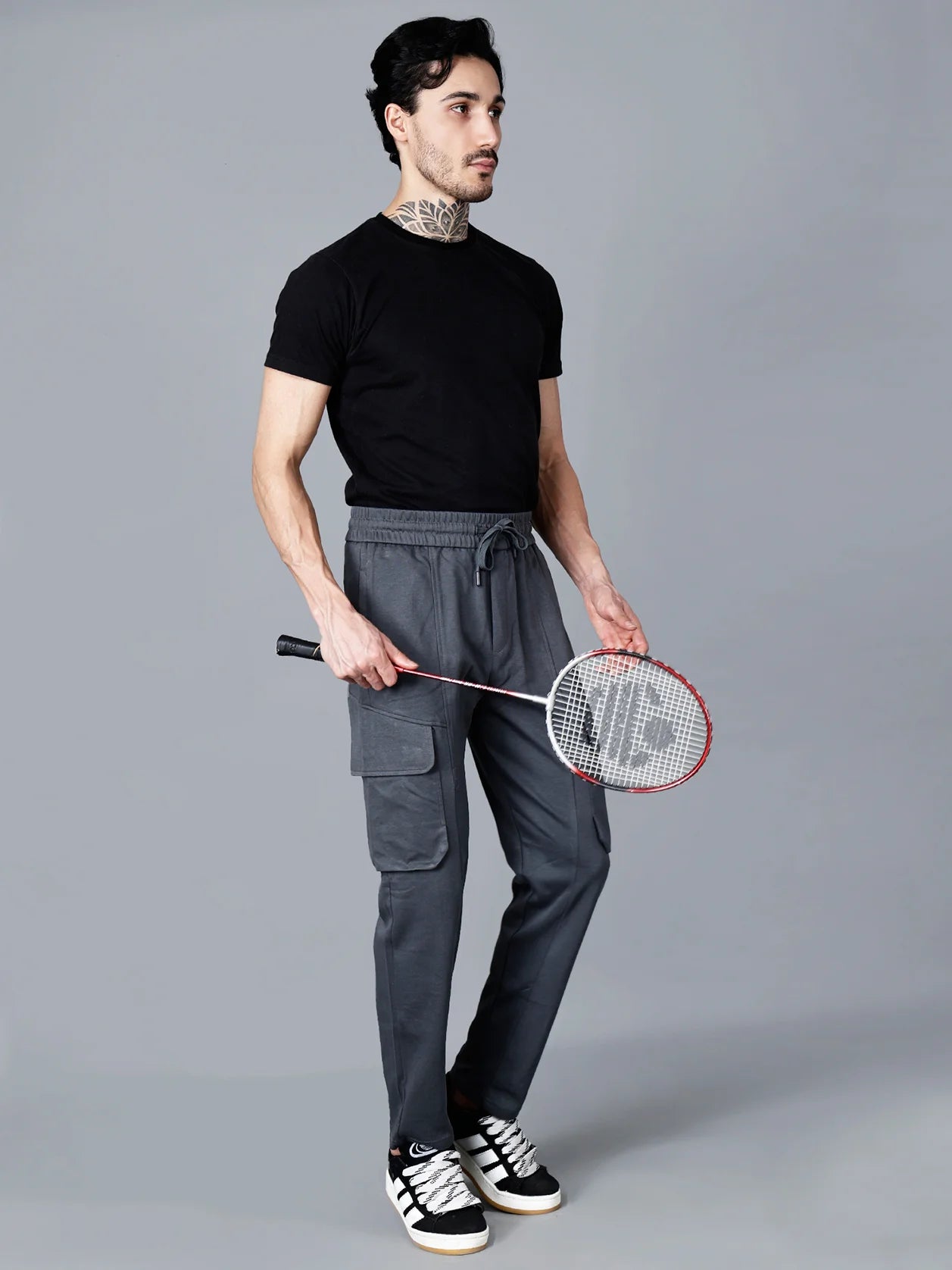 Discover the perfect combination of comfort and style with our Men's Charcoal Grey Cargo Track Pant. Experience the convenience of elastic waistband and cargo flap pockets, while the structured cotton-polyester fabric ensures durability. Shop now from anywhere in India on our website.