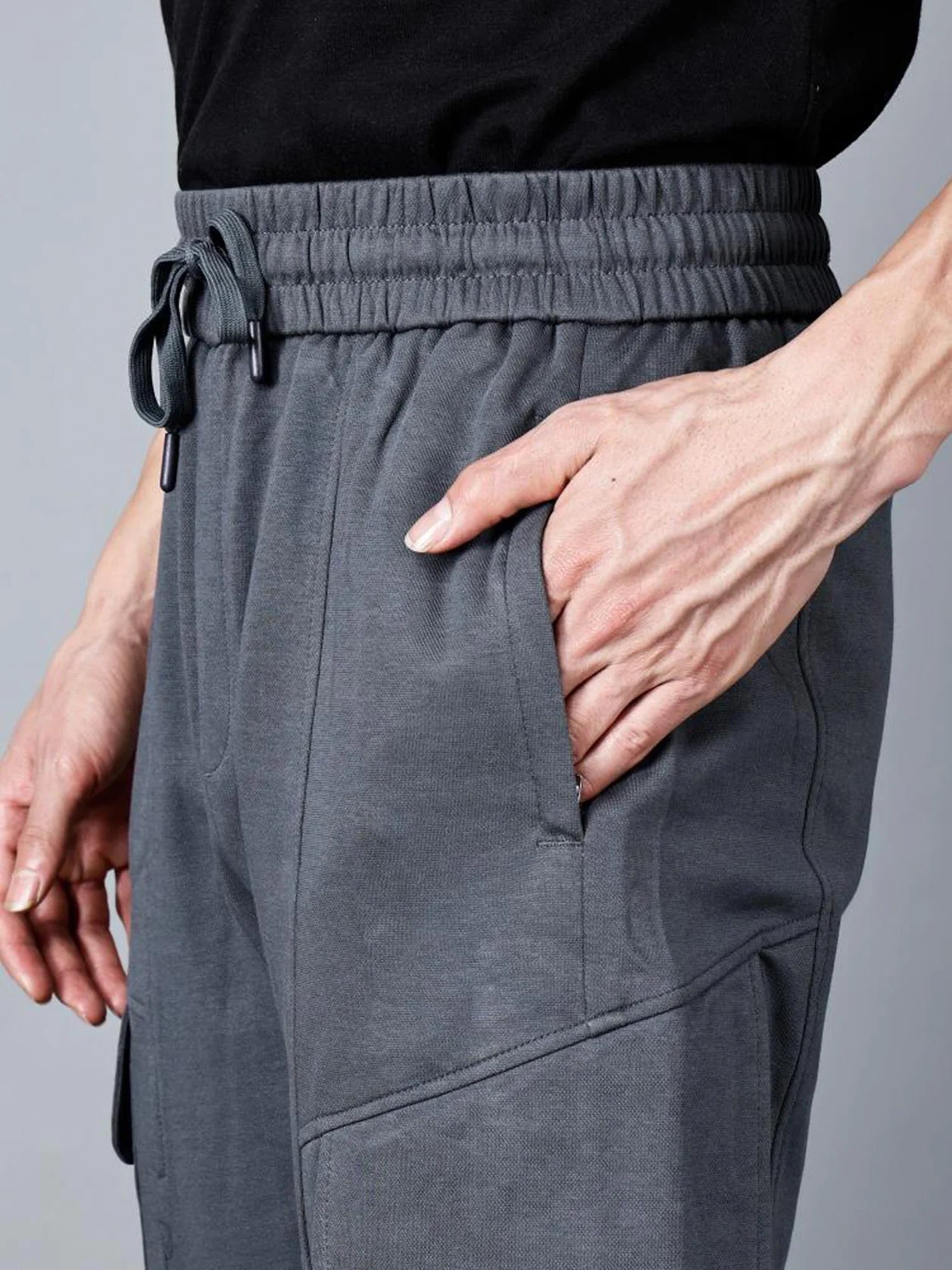 Discover the perfect balance of everyday comfort and streetwear-ready style with Fort Collins' men's charcoal grey track pant. Featuring cargo flap pockets, an elastic waistband, and structured cotton-polyester fabric, these pants are a must-have for any wardrobe. Shop online from anywhere in India.