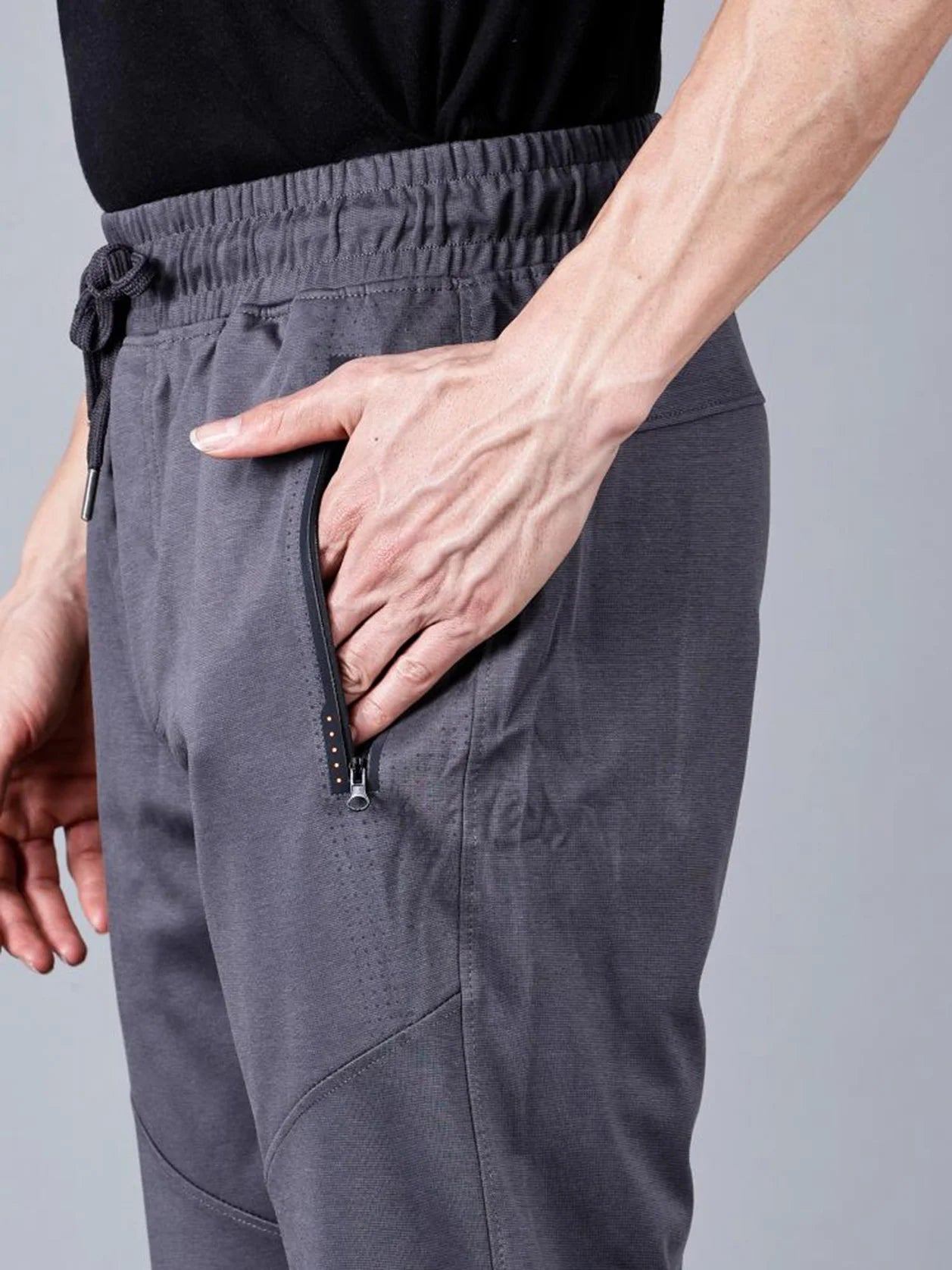 Explore the latest trend in men's fashion with our Men's Charcoal Grey Structured Track Pant equipped with convenient Zipper Pockets. Shop now for a stylish addition to your wardrobe from anywhere in India.