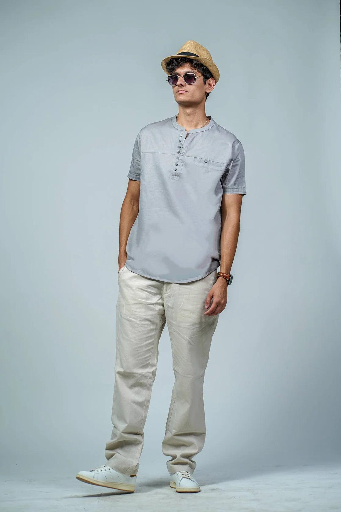 Expertly designed for the modern man, this grey Men's Kurta features a relaxed fit and a sophisticated mandarin collar. Complete with a chest pocket, this stylish T-shirt is a must-have for your wardrobe.