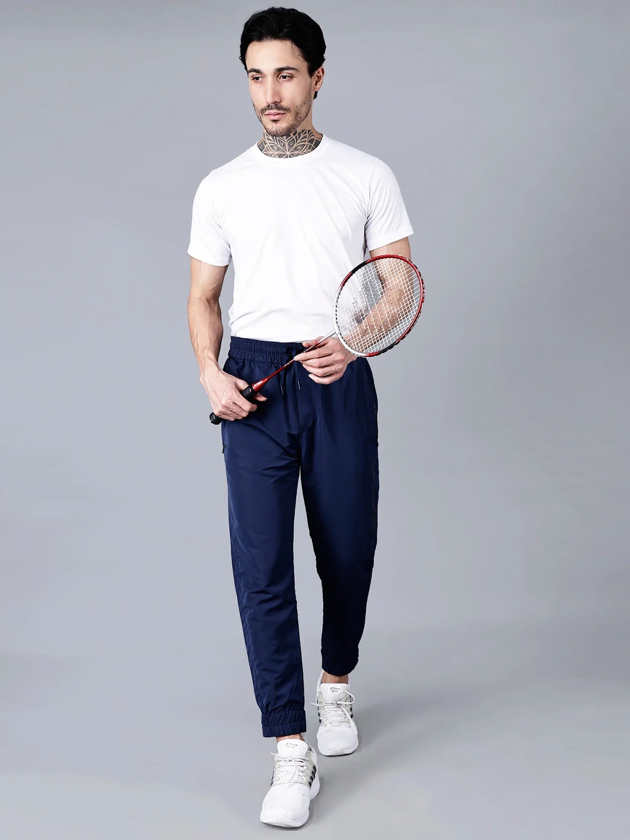 Discover the ideal combination of athletic fashion and daily ease with our Men's Navy Blue Track Pant. Featuring zippered pockets and an adjustable hem, it is the optimal choice for any active lifestyle. Purchase online from anywhere in India.