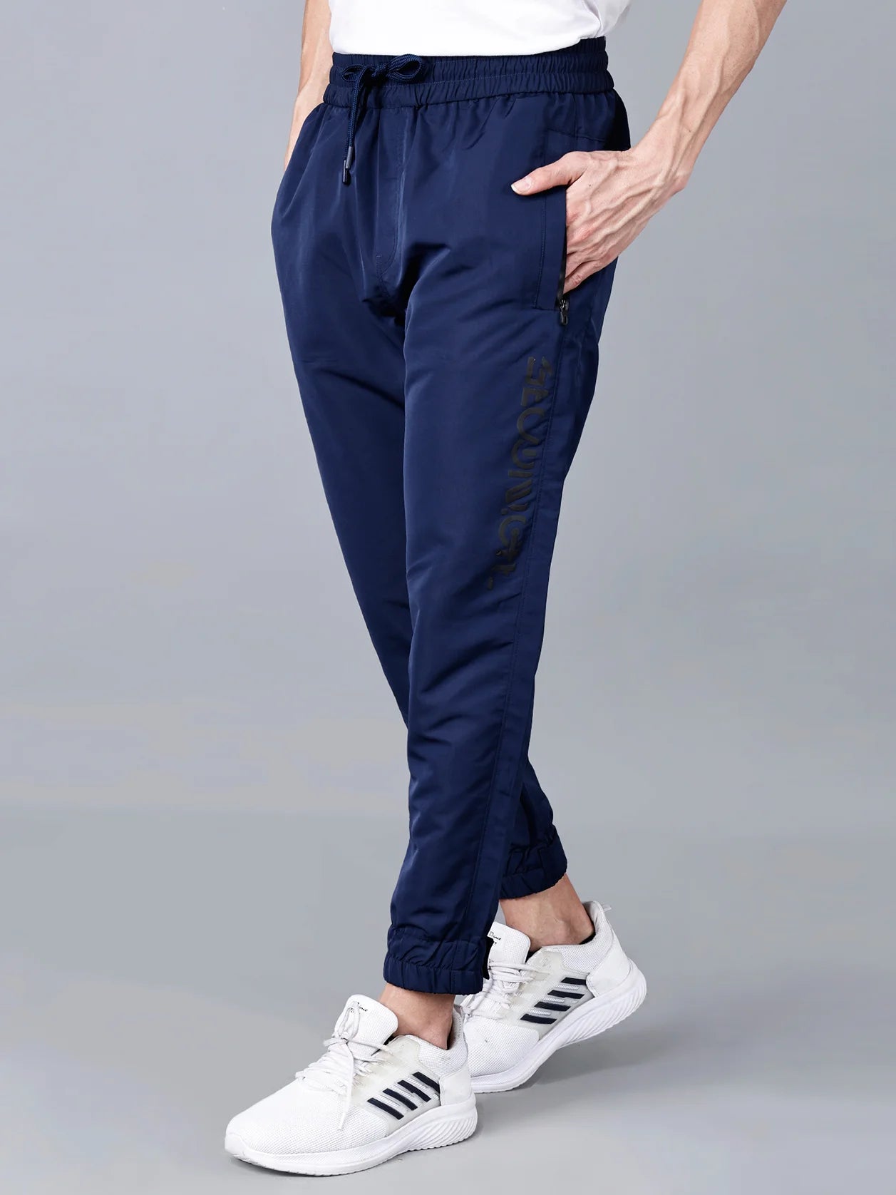 Introducing Fort Collins' men's navy blue track pants with zippered pockets and adjustable hem, the ideal combination of athletic fashion and daily ease. Shop online from any location in India.