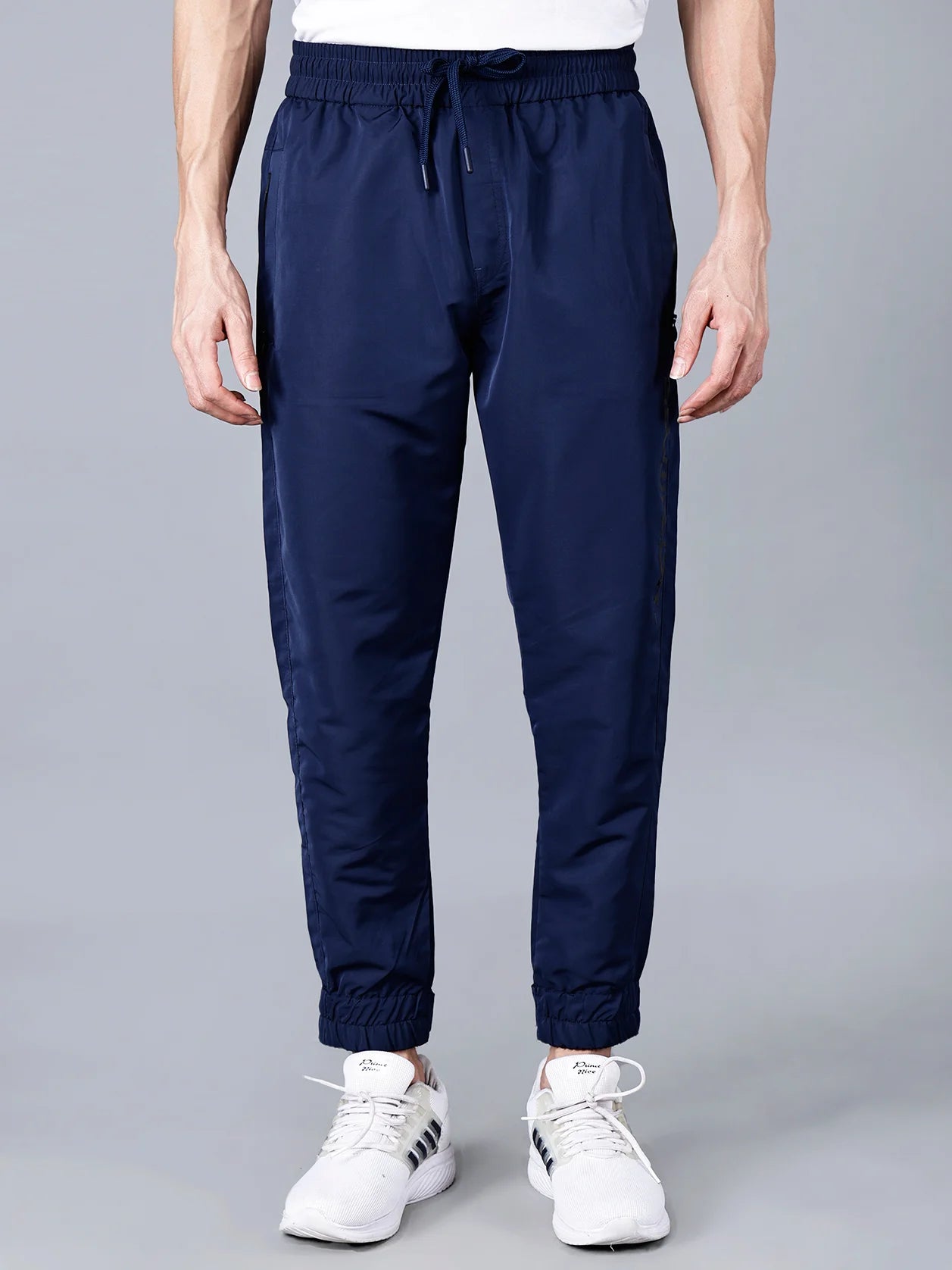 Experience the ultimate in comfort and style with our Men's Navy Blue Track Pant, featuring zippered pockets and an adjustable hem. Available for online purchase in India.