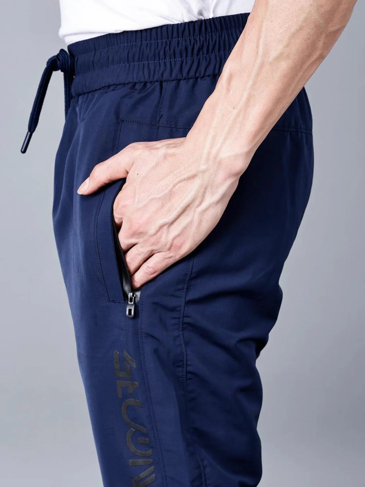 Experience the ultimate combination of athletic fashion and daily ease with our Men's Navy Blue Track Pant. Featuring zippered pockets and an adjustable hem, these pants are a must-have for any active lifestyle. Shop now from anywhere in India.