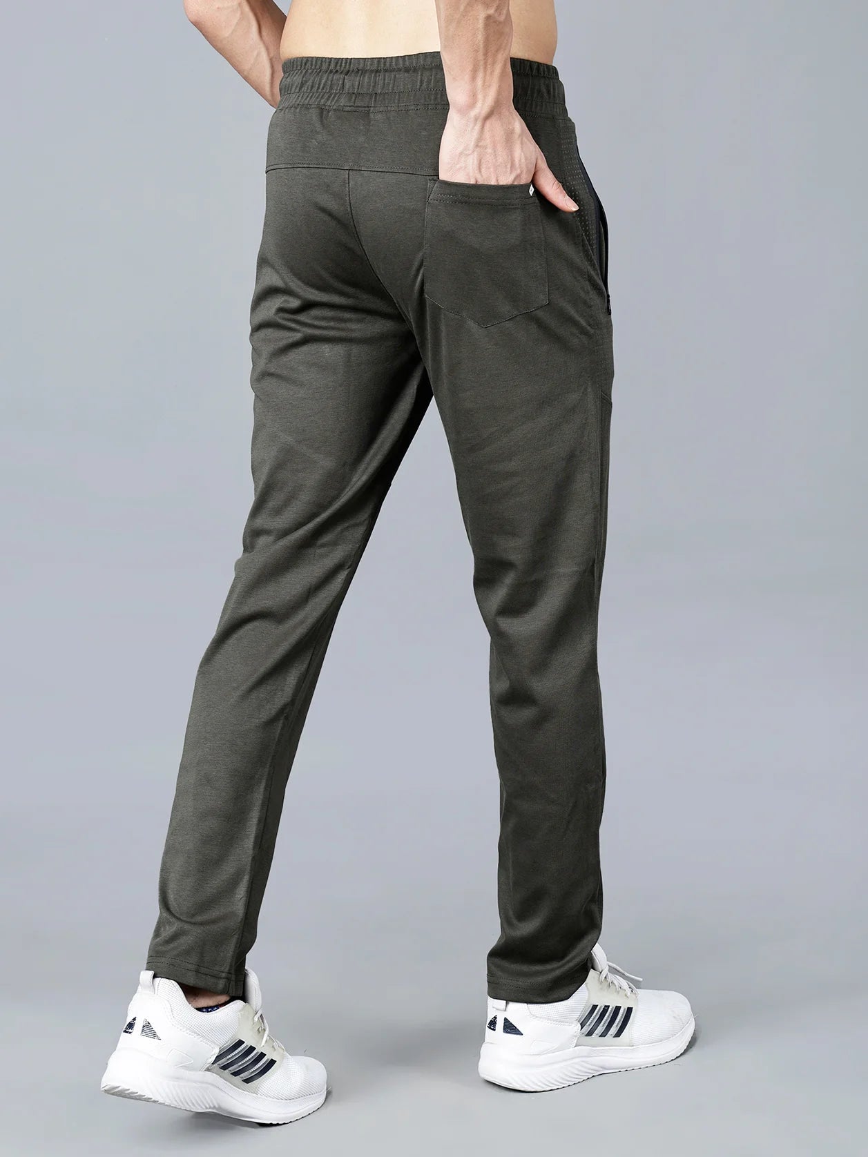 Discover the ultimate in comfort and style with our Men's Olive Green Structured Track Pant. Designed with a slim-tapered fit, articulated knee panels, and made of a cotton-polyester knit fabric, these pants feature zipper pockets for added convenience. Buy now from anywhere in India.