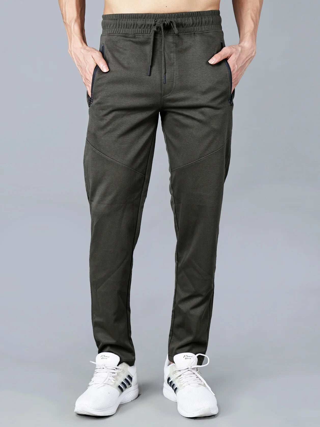Discover the perfect blend of comfort and style with our Men's Olive Green Structured Track Pant featuring zipper pockets, a slim-tapered fit, and articulated knee panels. Crafted from a cotton-polyester knit fabric, this garment is designed to provide ultimate comfort while maintaining a sleek, professional look. Buy now online from anywhere in India.