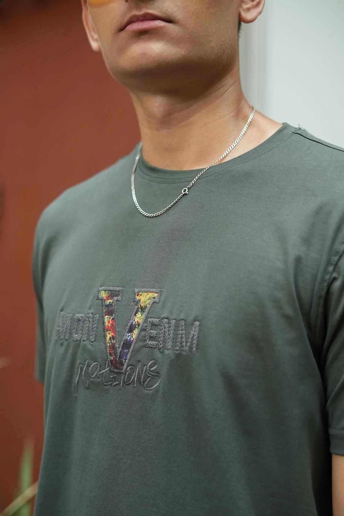 This Men's Black Round Neck Graphic Print T-Shirt with Embroidery from Fort Collins features embroidery and a comfortable round neck.