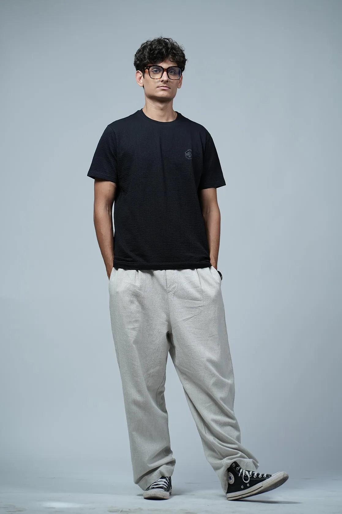 This Men's Structured Fabric T-Shirt features a Solid Black design, with a Round Neck and Chest Logo.