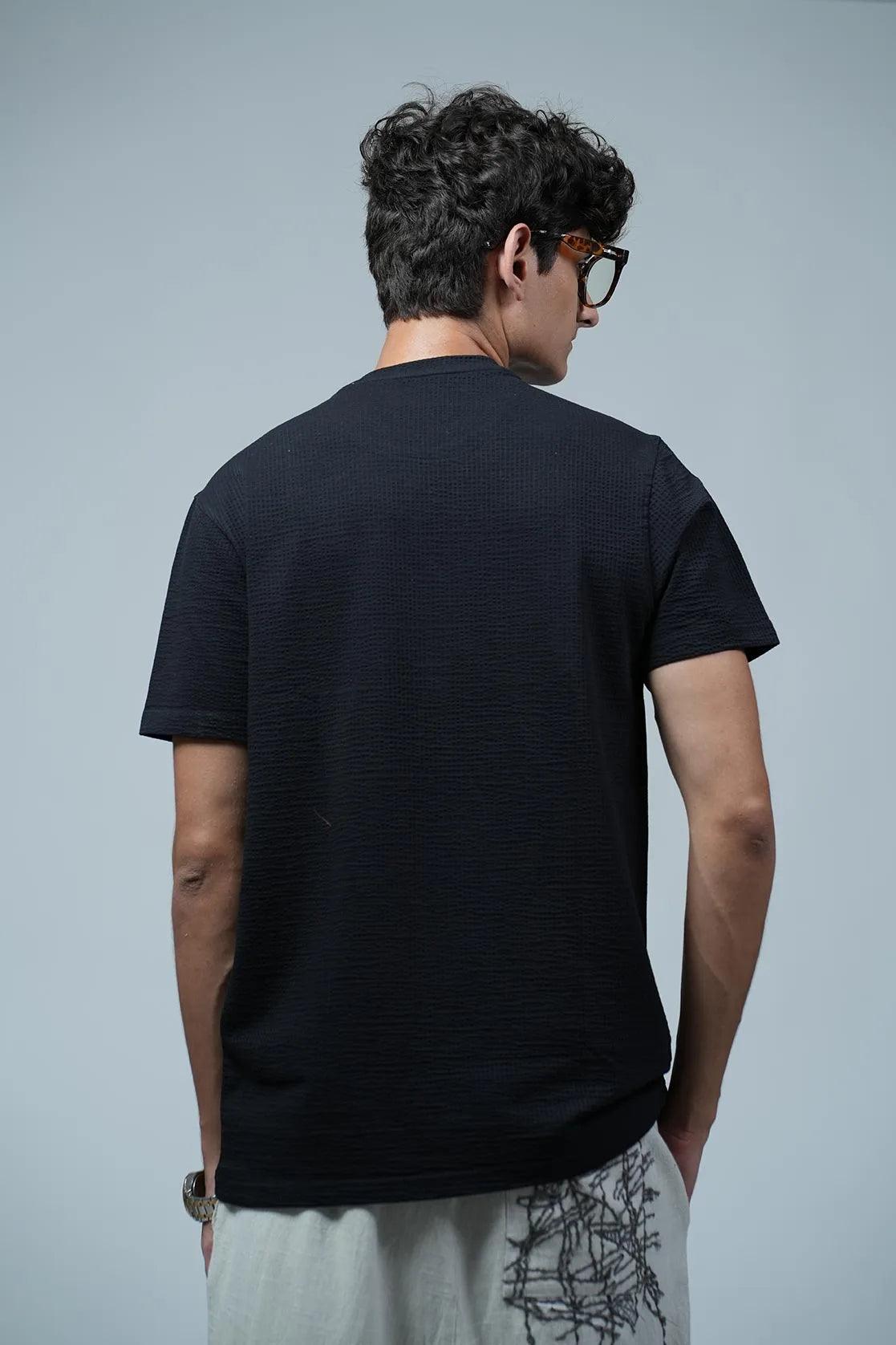 This structured black round neck t-shirt for men, from Fort Collins, showcases a chest logo.