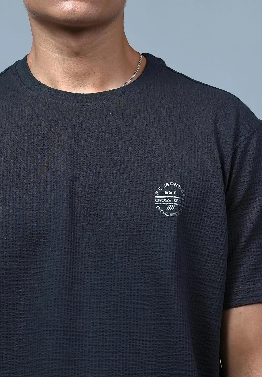This Men's Structured Fabric T-Shirt features a classic round neck design with a solid black color and a chest logo, making it a timeless and versatile addition to any wardrobe.