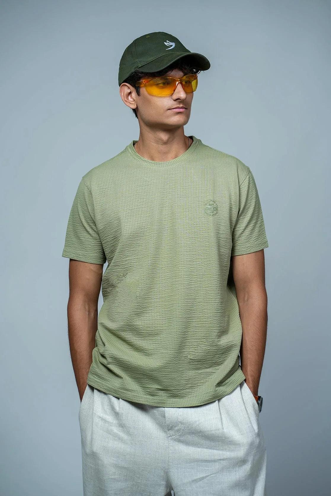 The Fort Collins Men's Structured Fabric Green T-Shirt boasts a solid color design and features a classic round neck style. The chest logo adds a touch of branding to this high-quality shirt.