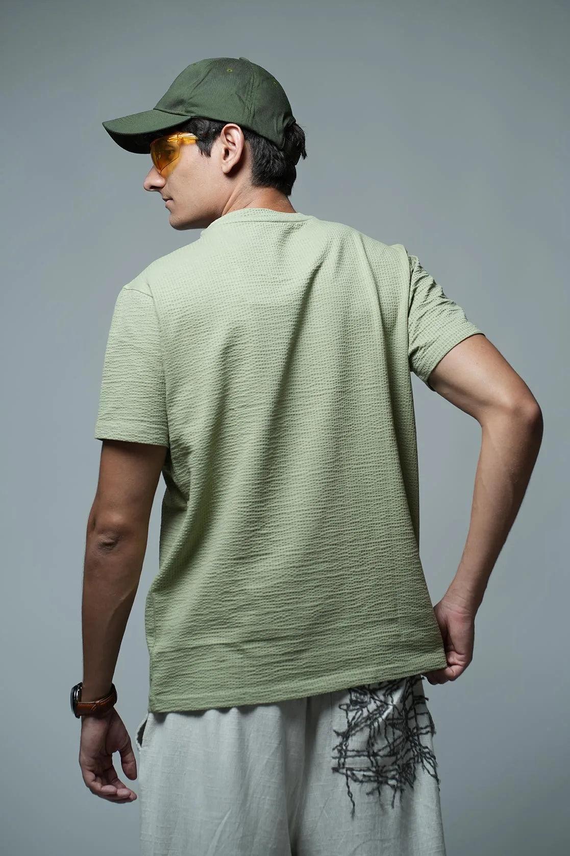 This Men's Structured Fabric Solid Green Round Neck T-Shirt features a Chest Logo, making it a stylish choice for any occasion