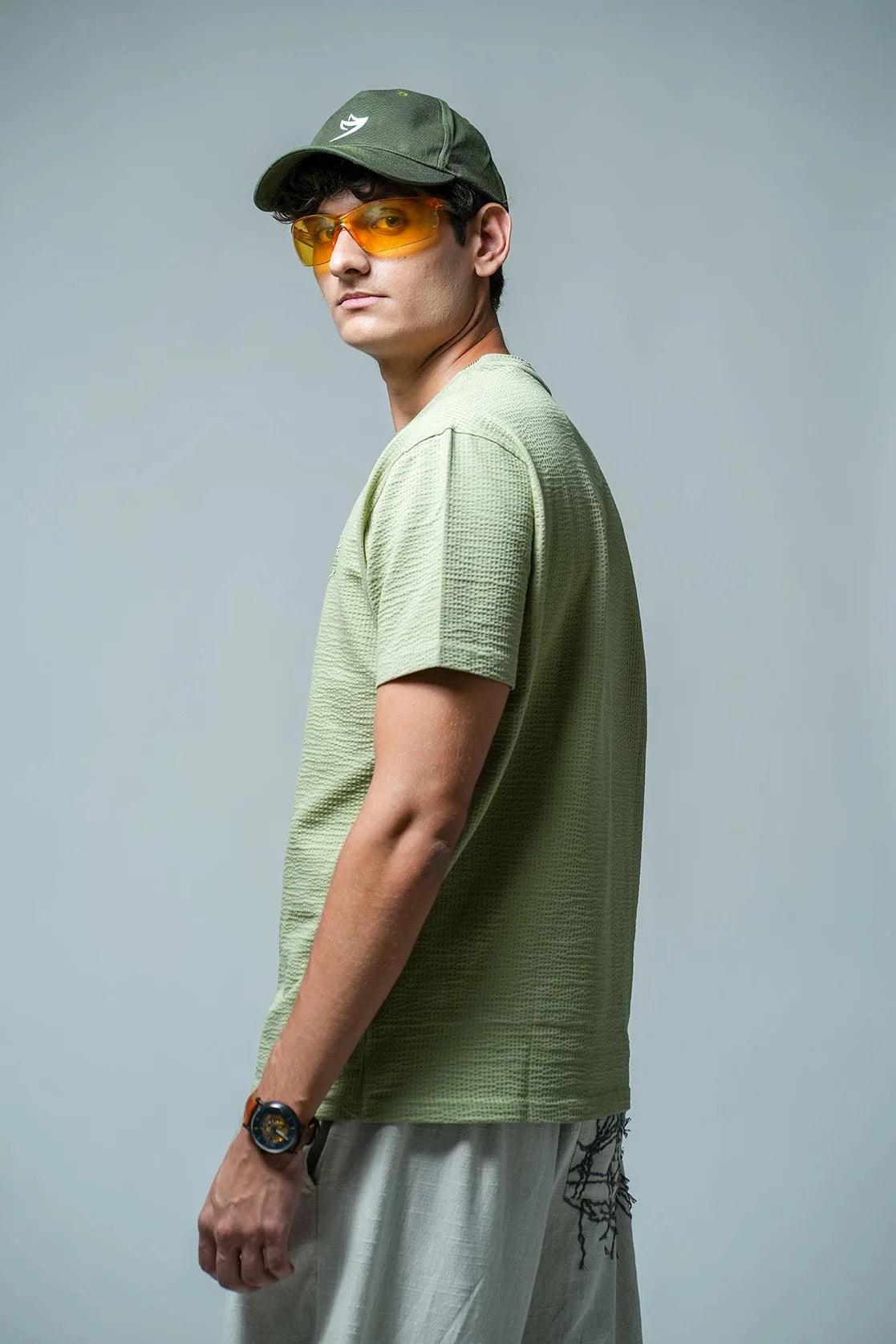 This Men's Structured Fabric Solid Green Round Neck T-Shirt from Fort Collins features a chest logo, making it a stylish and practical addition to any wardrobe.