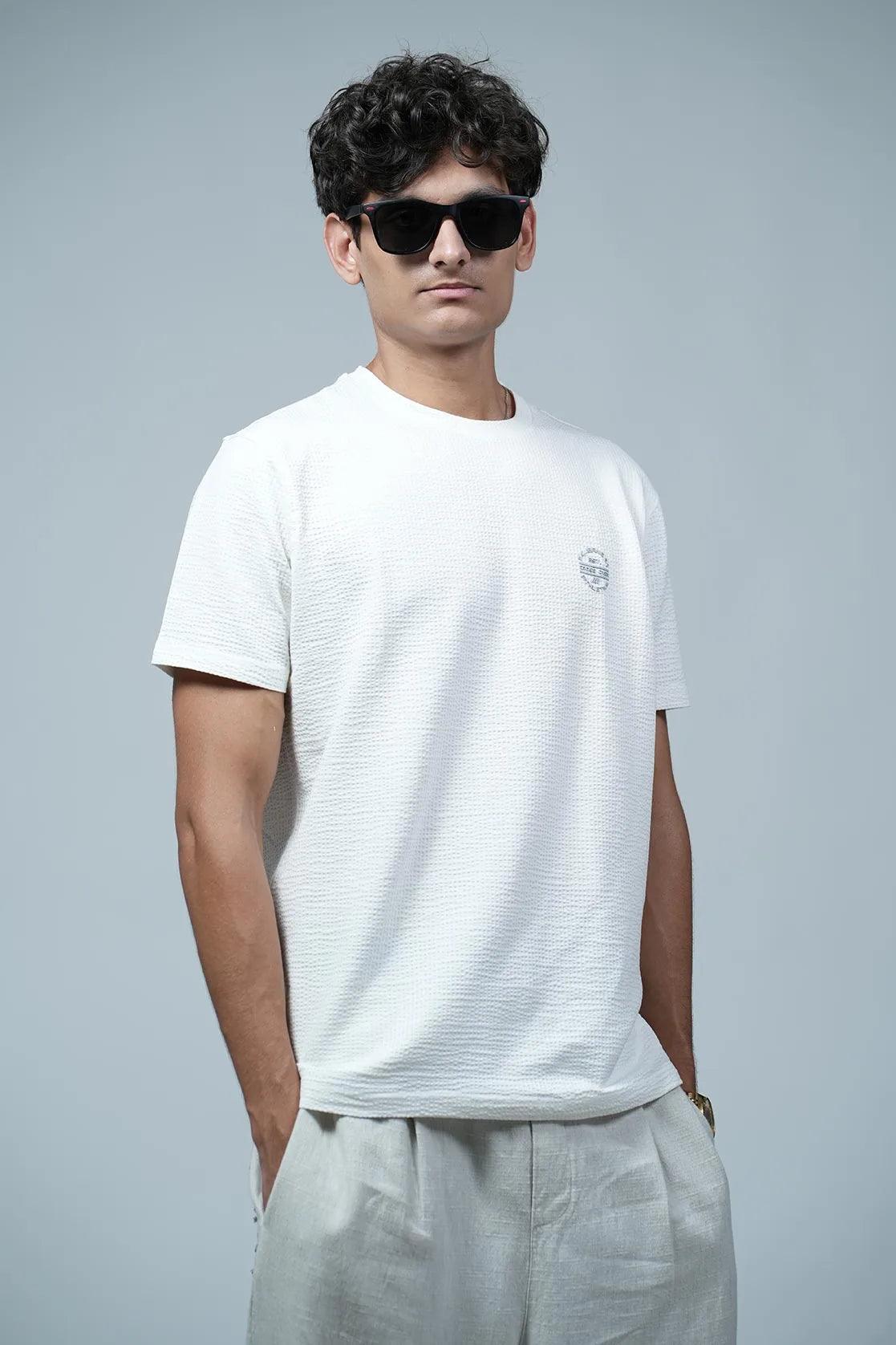 Expertly crafted with structured fabric, this off-white round neck t-shirt for men by Fort Collins features a solid design and a chest logo, adding an element of sophistication to your wardrobe.