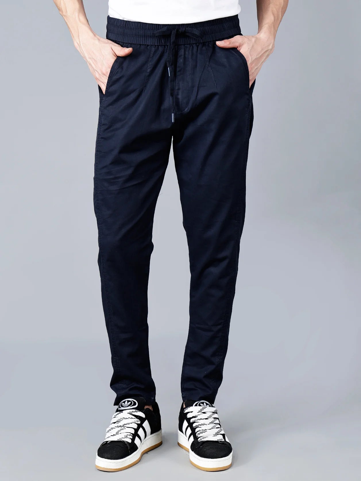 Order now for anywhere in India - Fort Collins Men's Navy Cotton Track Pants, featuring a smart taper fit, elastic waistband with drawstring closure, and a multi-pocket design. These stylish and breathable casual pants are perfect for lounging, travel, or everyday wear. Shop now online.