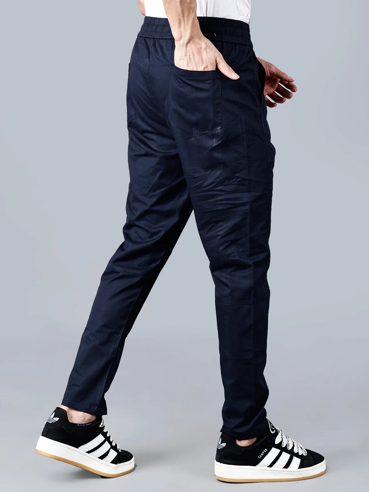 Upgrade your casual wardrobe with Fort Collins Men's Dark Navy Cotton Track Pants. Featuring a smart taper fit, elastic waistband, and multi-pocket design, these pants are perfect for lounging, traveling or daily wear. Shop now for worldwide shipping within India.