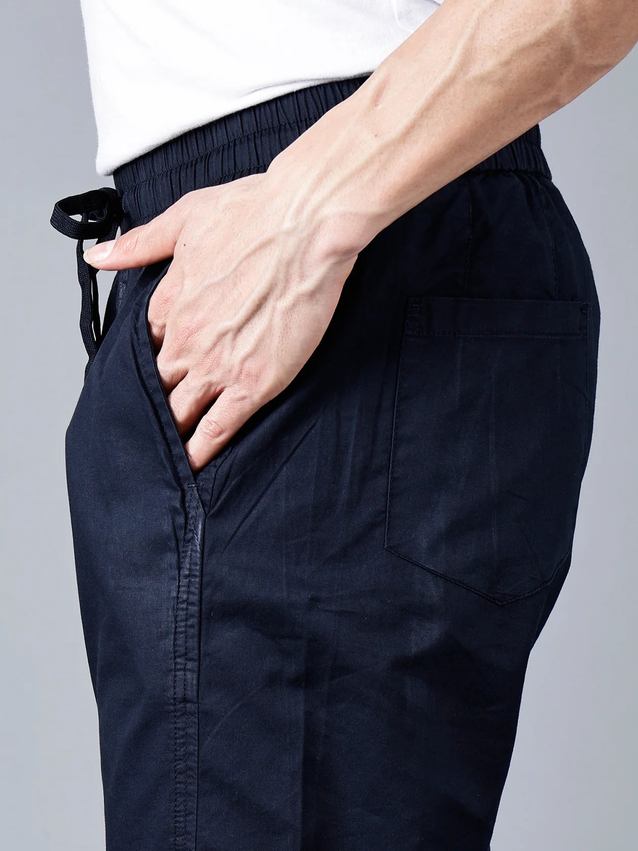 Discover our smart taper fit, navy cotton track pants for men with an elastic waistband and drawstring closure. Expertly designed for comfort and style, our pants feature a multi-pocket design and are perfect for lounging, travel, or daily use. Shop now for unbeatable quality, available online for delivery anywhere in India.