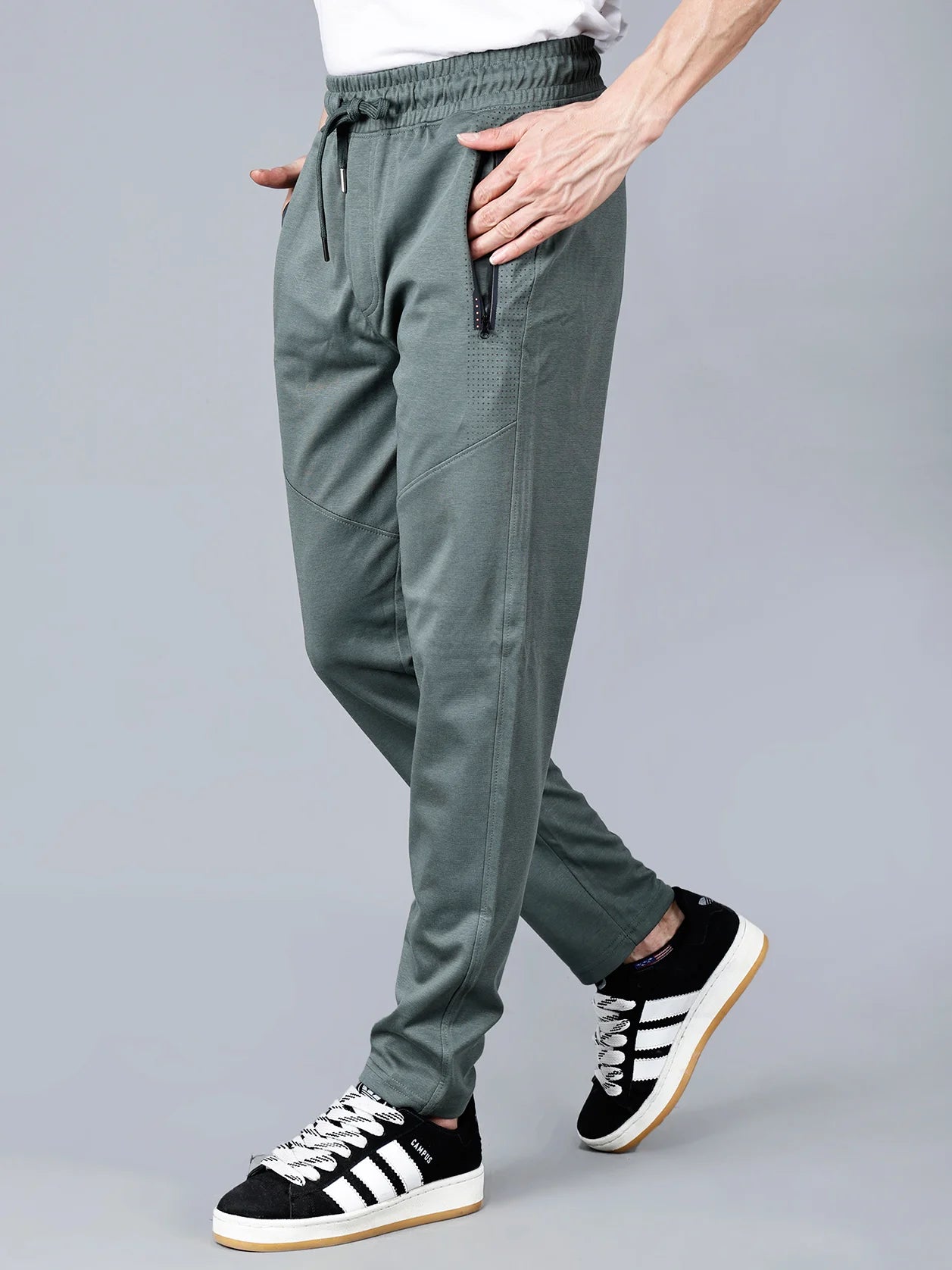 Men’s pista green slim tapered track pants with zipper pockets and articulated knees – Fort Collins athleisure joggers made from breathable cotton-poly blend, ideal for gym, travel, and casual wear. Shop now online from anywhere in India.