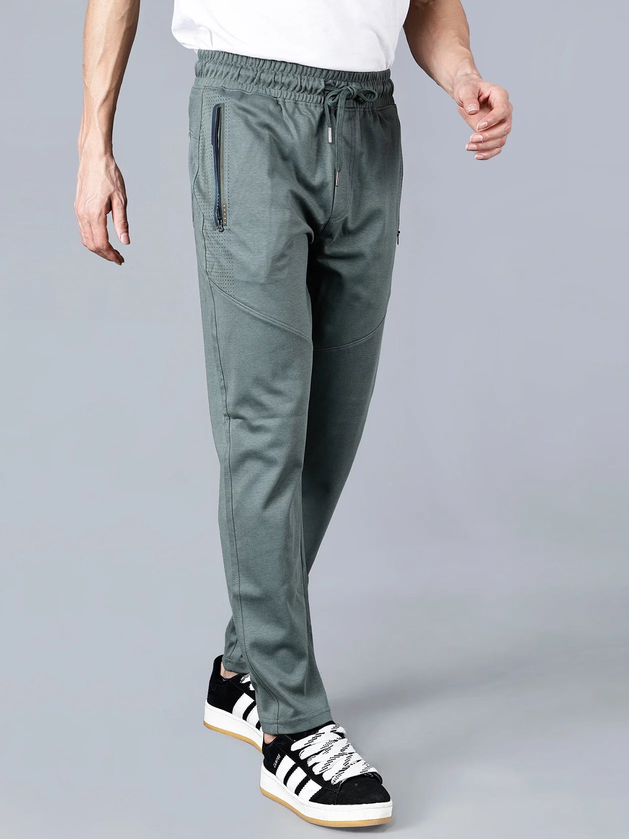 Discover the perfect blend of comfort and style with Fort Collins' pista green slim tapered track pants for men. Designed for men, these athleisure joggers feature zipper pockets and articulated knees, making them ideal for any occasion - whether it be at the gym, while travelling, or for casual wear. Made from a breathable blend of cotton and polyester, these track pants are a must-have for your wardrobe. Shop now for this versatile piece, available online in India.