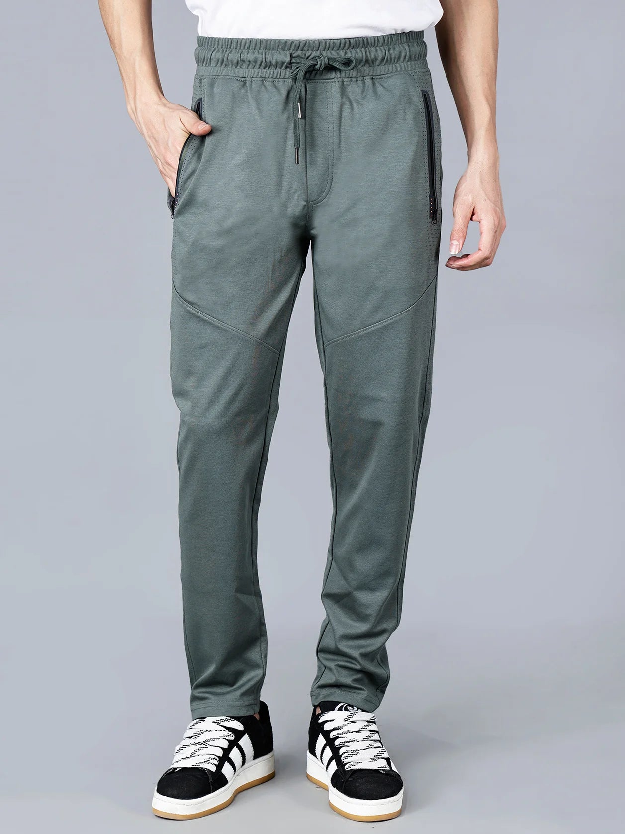 Fort Collins' pista green slim fit structured track pants for men feature zipper pockets and articulated knees for added practicality. Made from a breathable cotton-poly blend, these athleisure joggers are perfect for a variety of activities, making them a versatile option for gym, travel, and casual wear. Get yours today from anywhere in India with easy online shopping.