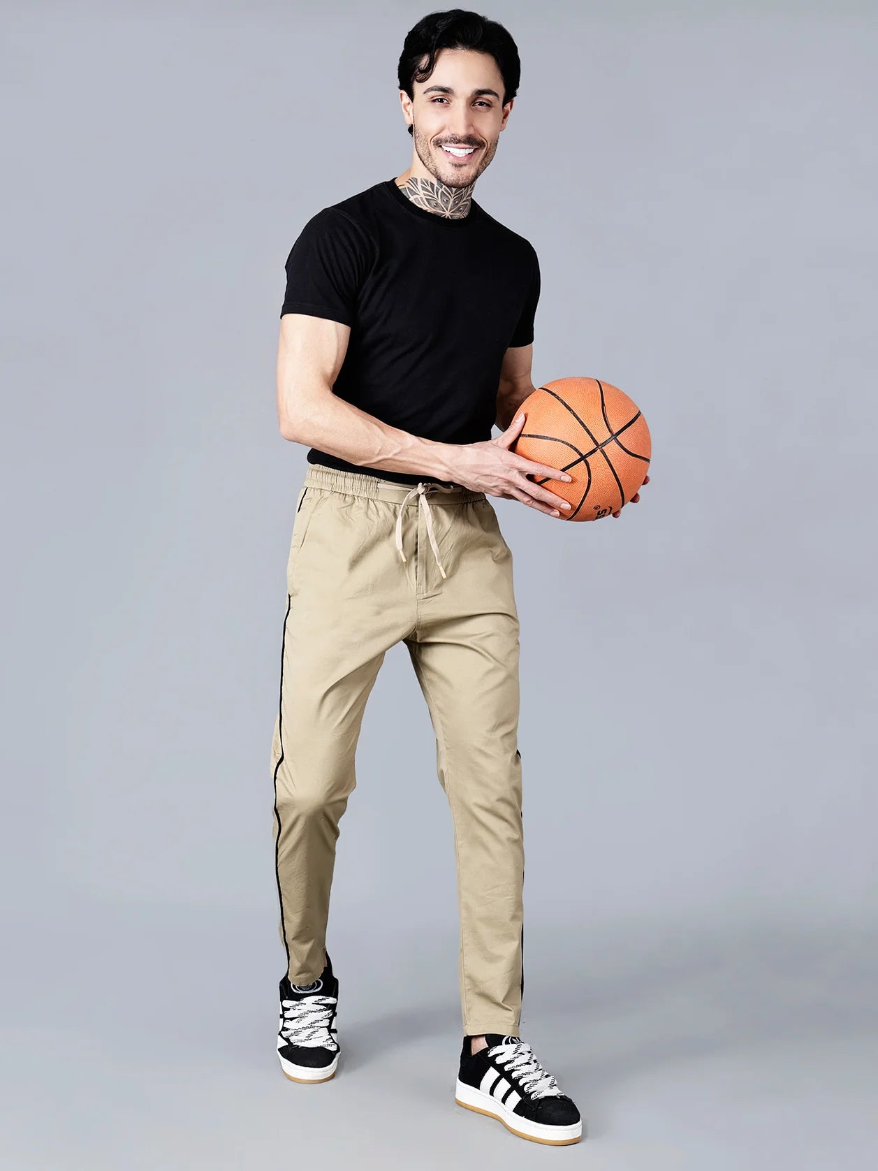 Enhance your wardrobe with our slim fit activewear track pants for men in khaki, featuring a black side stripe, made with a comfortable stretch cotton blend fabric and equipped with zipper pockets. These casual joggers are perfect for everyday wear and add a touch of streetwear style to your look. Purchase now for a trendy upgrade to your clothing collection, available for online purchase from anywhere in India.
