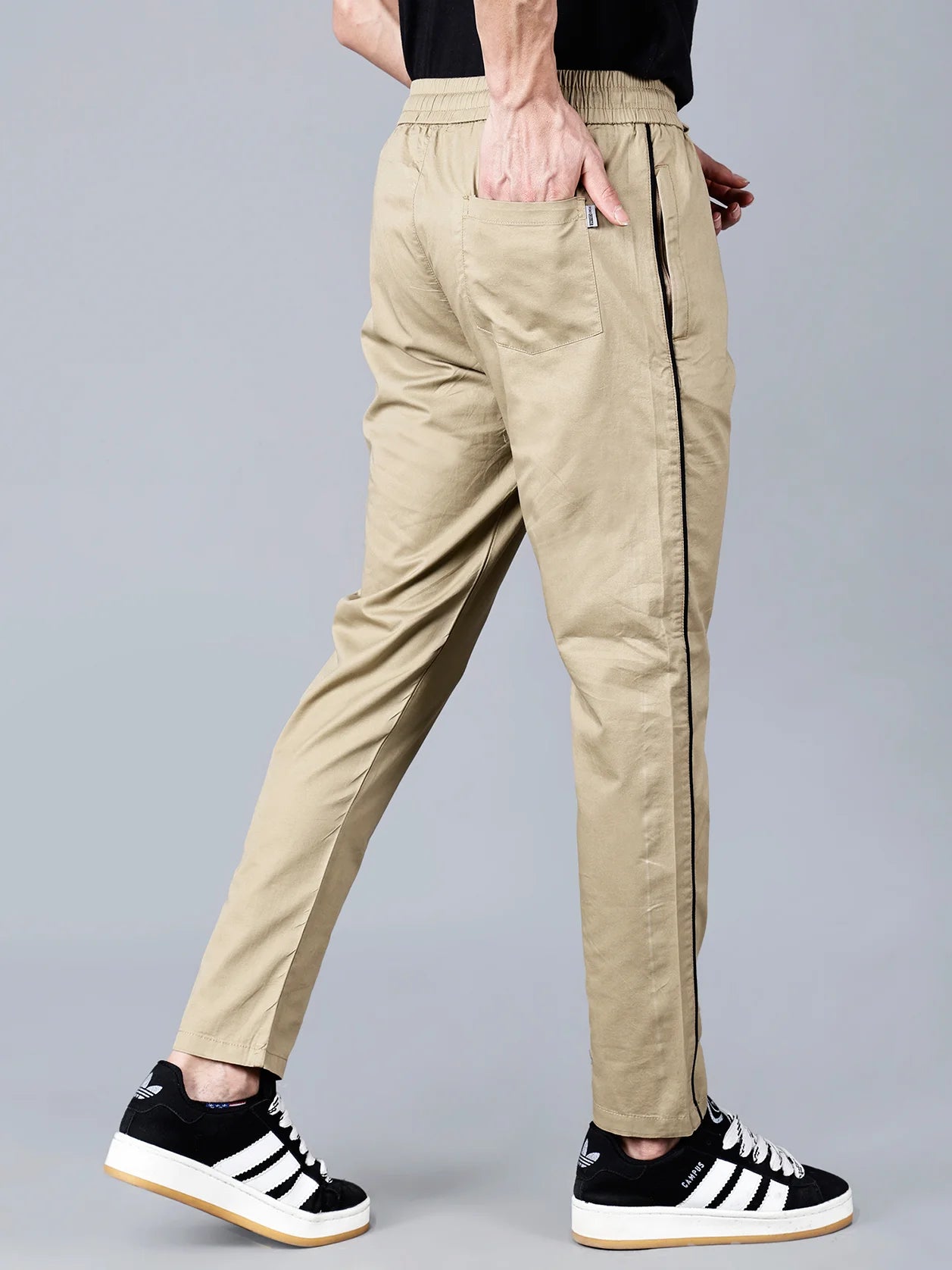 Upgrade your clothing collection with these slim fit, khaki color track pants for men from Fort Collins. Featuring a black side stripe, stretch cotton blend fabric and zipper pockets, these casual joggers are perfect for everyday comfort and streetwear appeal. Shop now online from anywhere in India for a trendy look.