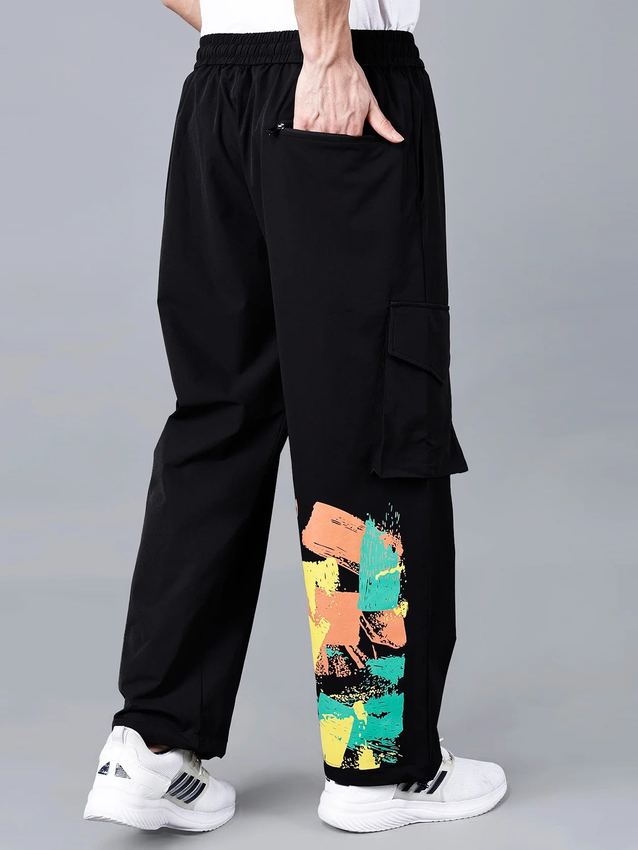 Experience the sleek design of our Solid Black Cargo Track Pants for Men, featuring a vibrant Multicolor Brushstroke Print and a striking Y-3 yellow patch. Designed for style and comfort, these relaxed fit pants are perfect for the gym, traveling, and streetwear fashion. Order now online from India and have them shipped directly to your doorstep.