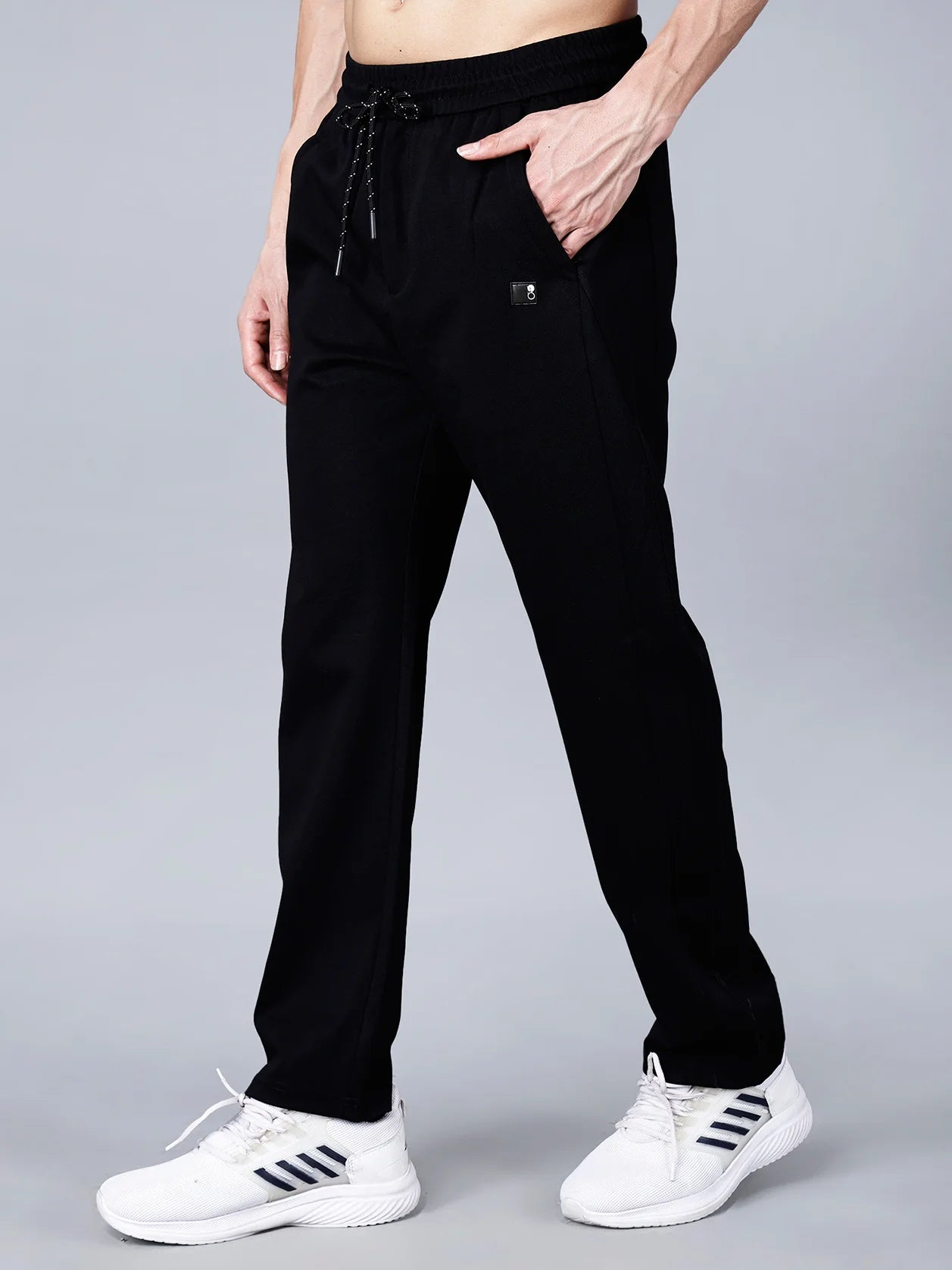 Black cotton track pants for men by Fort Collins featuring a smart taper fit, elastic waistband with drawstring, and practical pocket design for stylish comfort. Shop now online for trendy track pant in India.