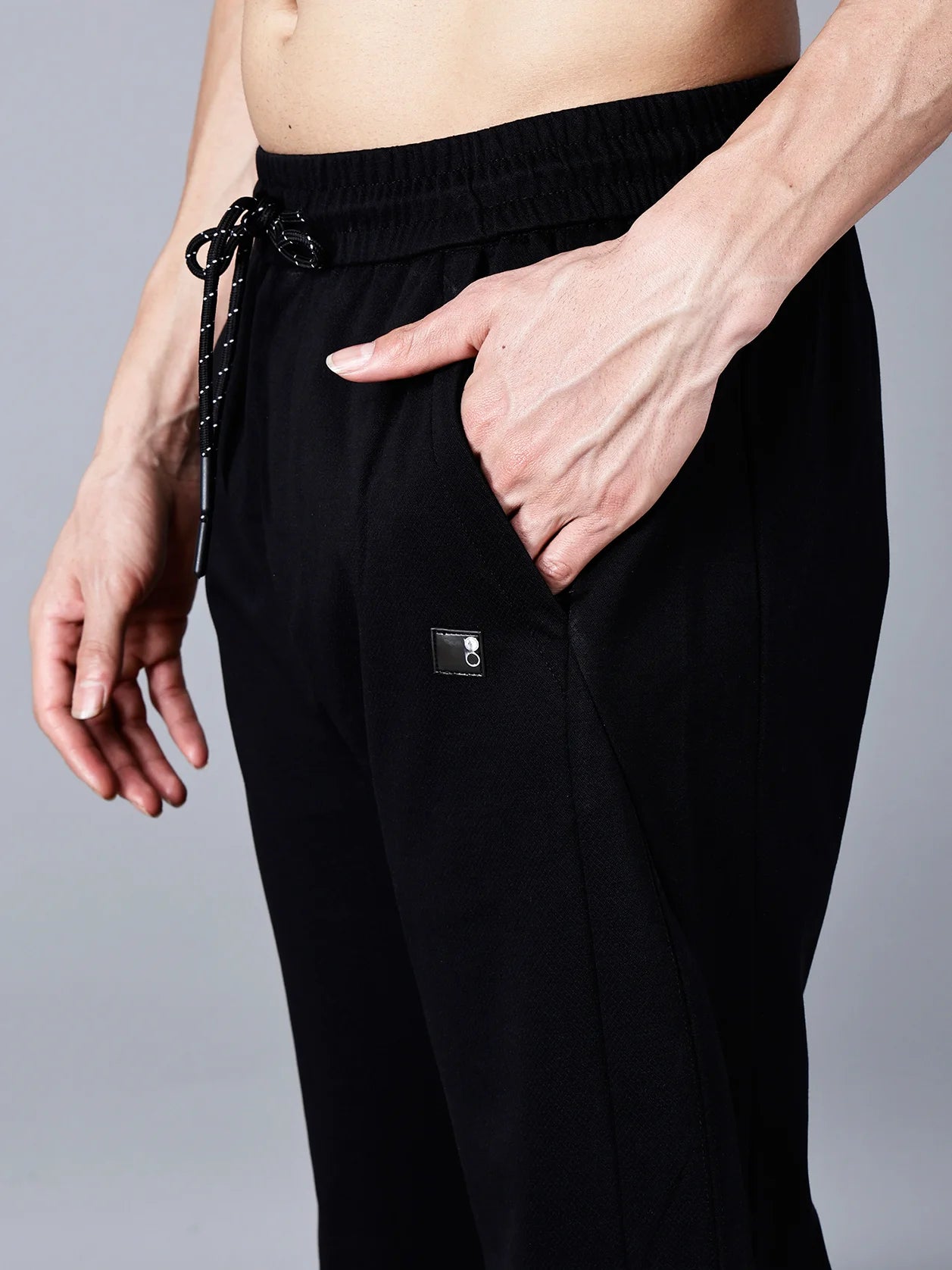 Feel the ultimate comfort and style with Fort Collins black cotton track pants for men, featuring a smart taper fit, elastic waistband with drawstring, and practical pocket design. Shop now for trendy track pants online in India.