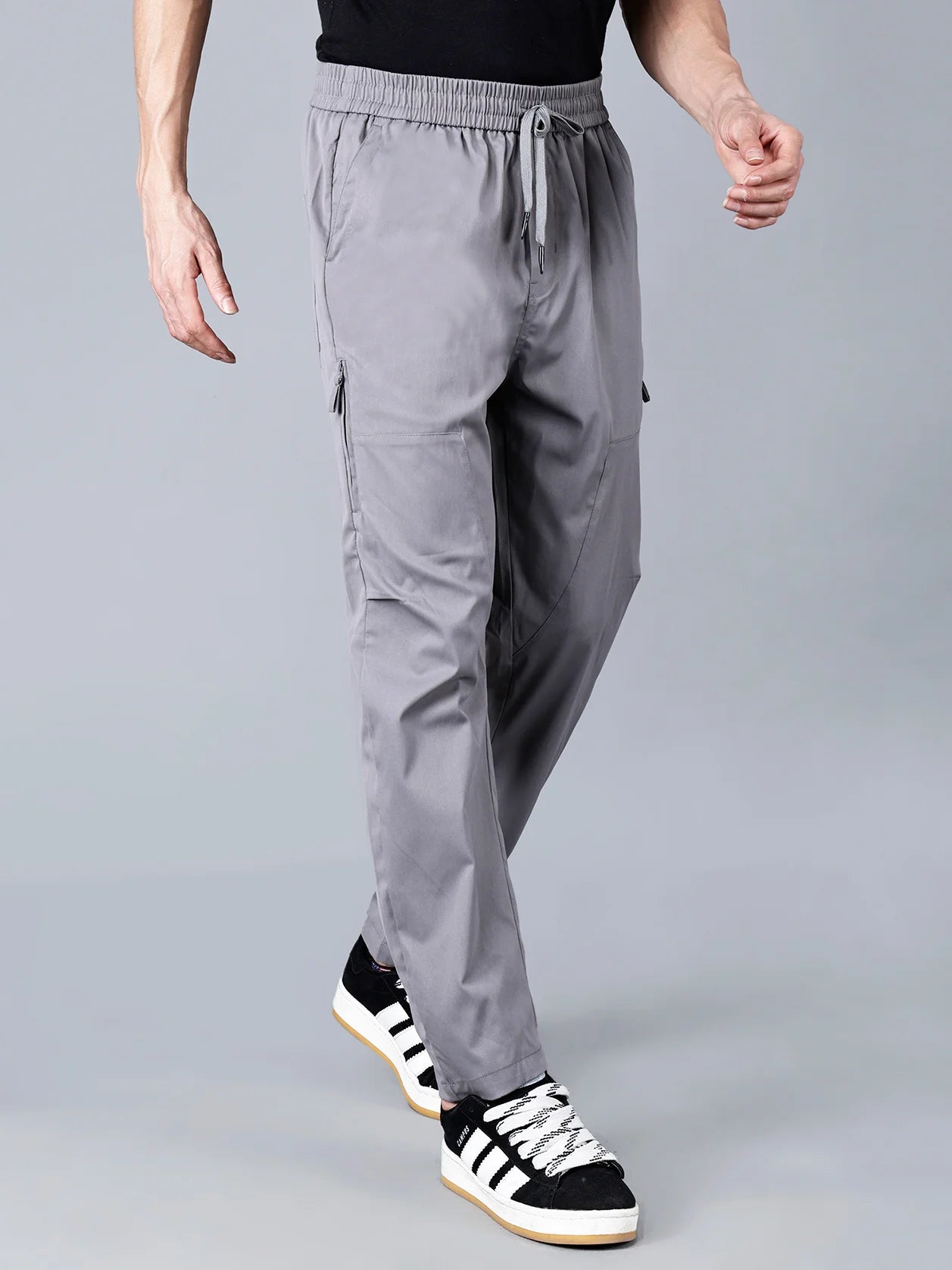 Discover comfort, style, and practicality in Fort Collins' grey cargo track pants for men. This versatile piece, featuring a zippered side pocket, is perfect for everyday wear or workouts. Shop now for a trendy addition to your wardrobe, available online across India.