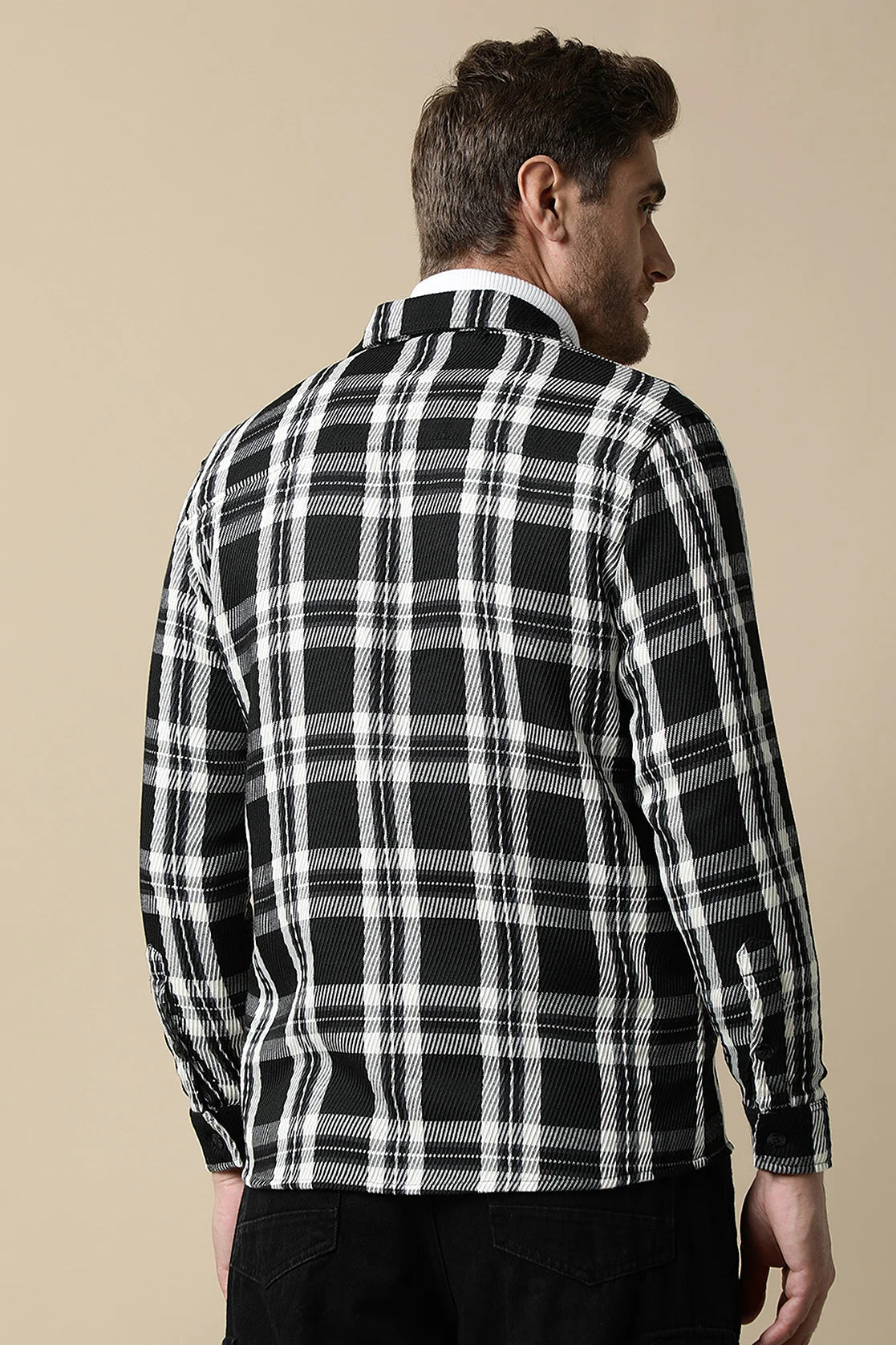 The Fort Collins Men's Black Knitted Plaid Shacket is a trendy wardrobe staple available for purchase online from anywhere in India.