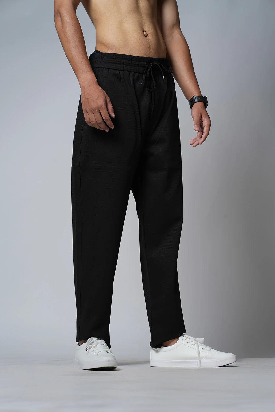 Obtain the Fort Collins Men's Black Track Pant with Zipper Pockets from an online retailer in India.