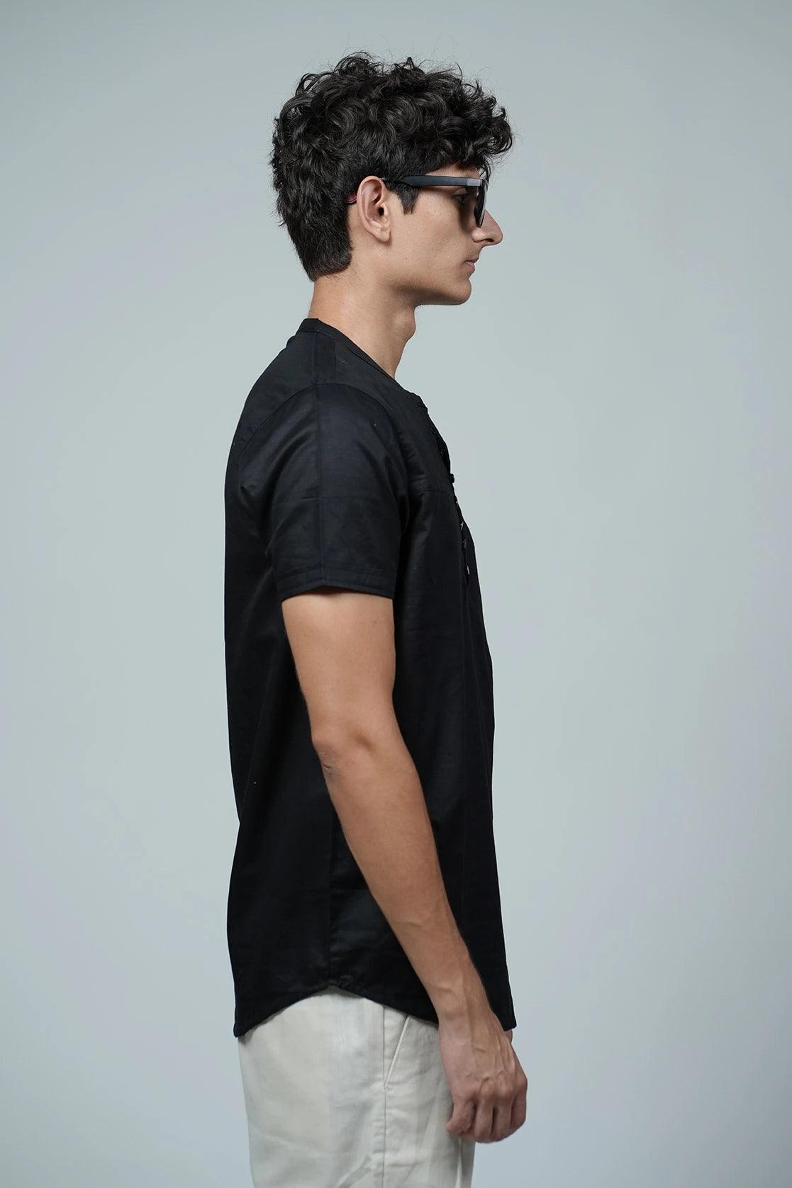 This Men's Black Relaxed Fit Mandarin Collar Kurta T-Shirt includes a convenient chest pocket and is designed with a loose, comfortable fit.