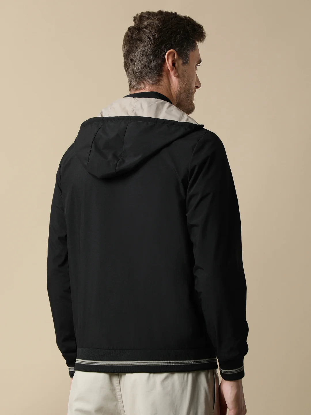 Shop for a stylish wardrobe from anywhere in India with the Fort Collins Men's Black Reversible Windbreaker, featuring a detachable hood. Order now online.