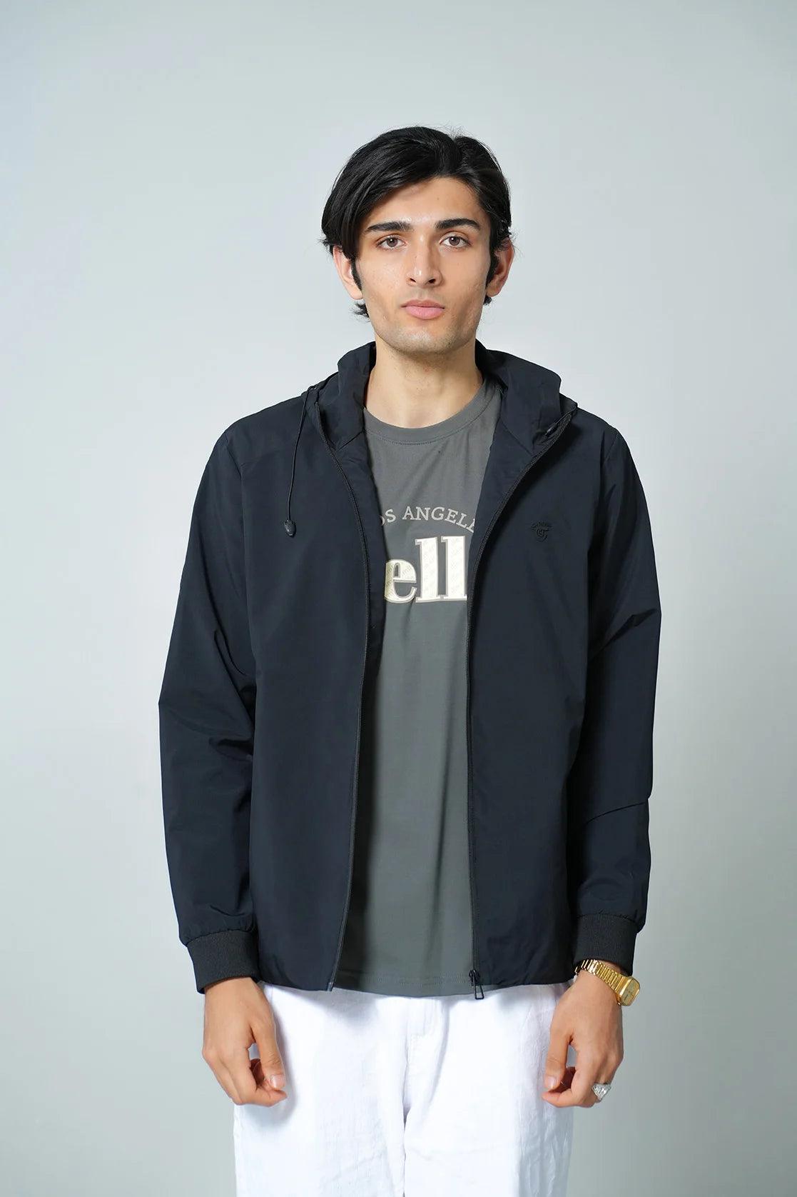 This windbreaker jacket, available for purchase in India, features a sleek black design and an adjustable hood. It is designed specifically for men and offers a slim fit for a stylish look.